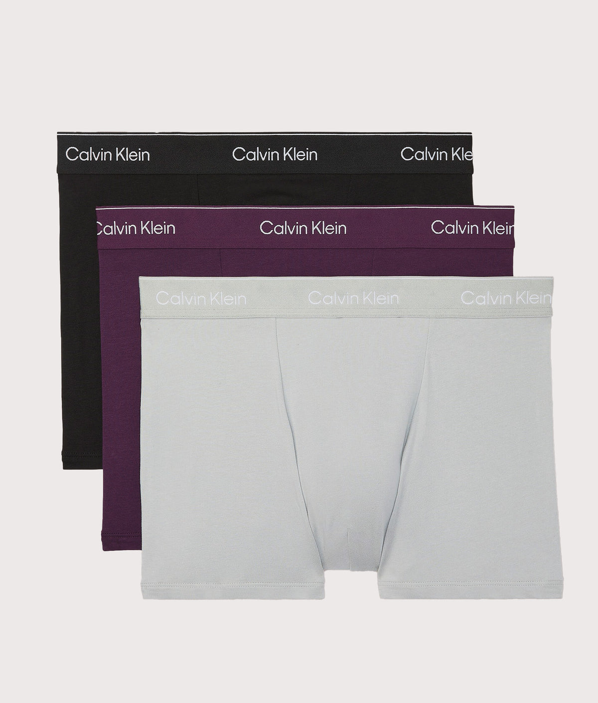 Calvin Klein 3 Pack Relaxed Fit Trunks in Black, Harbor Mist and Dark Purple at EQVVS. Front shot.