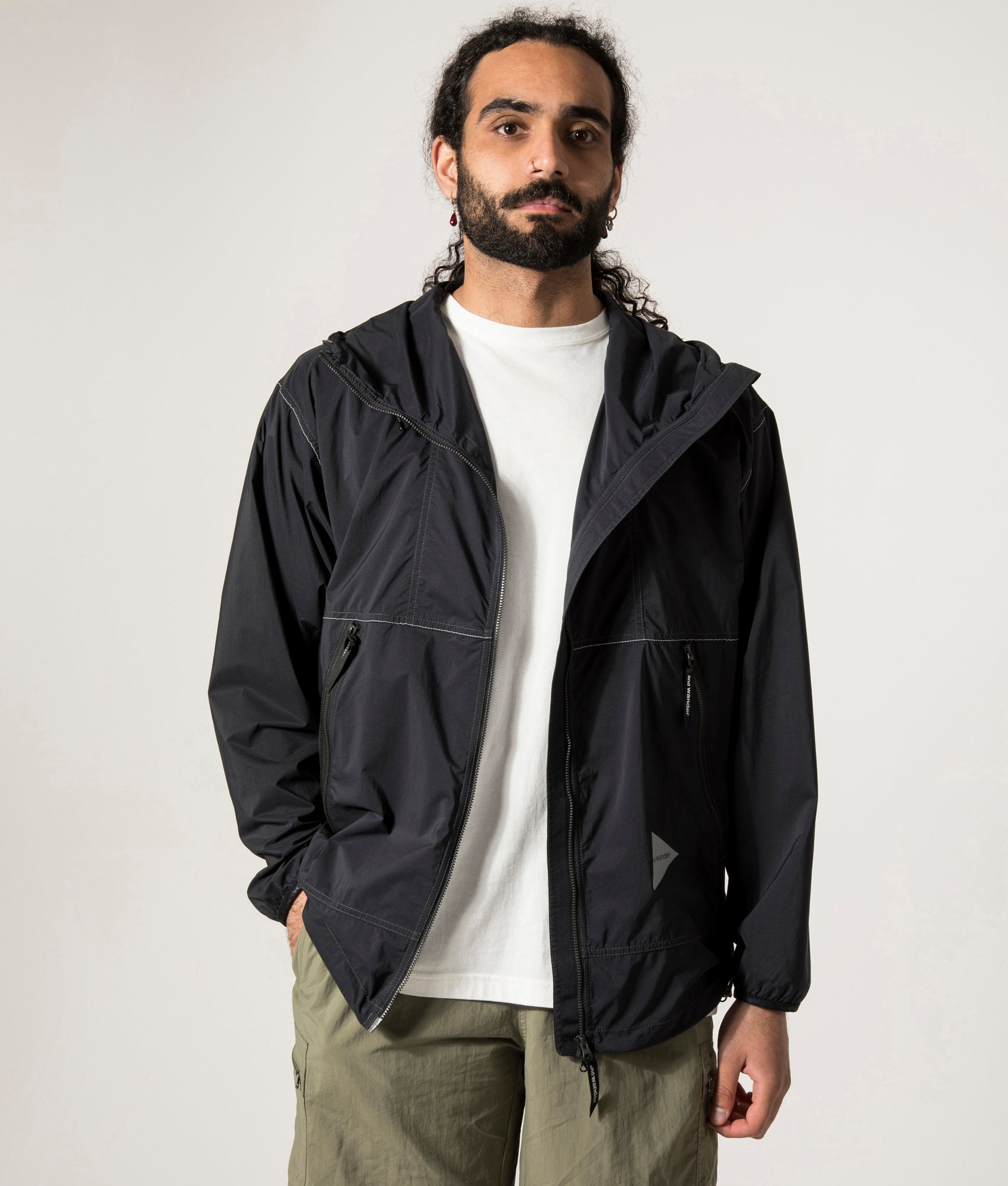 and wander Pertex Wind Jacket in Black at EQVVS. Open Jacket Model Shot.