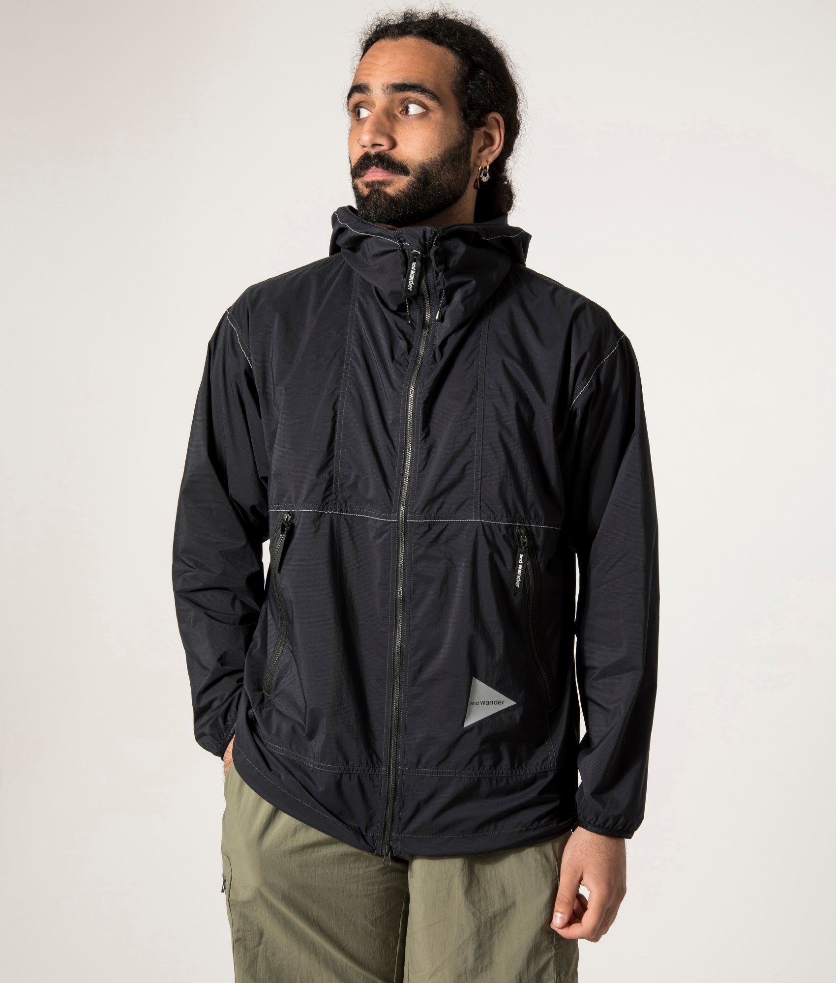 and wander Pertex Wind Jacket in Black at EQVVS. Front Model Shot. 