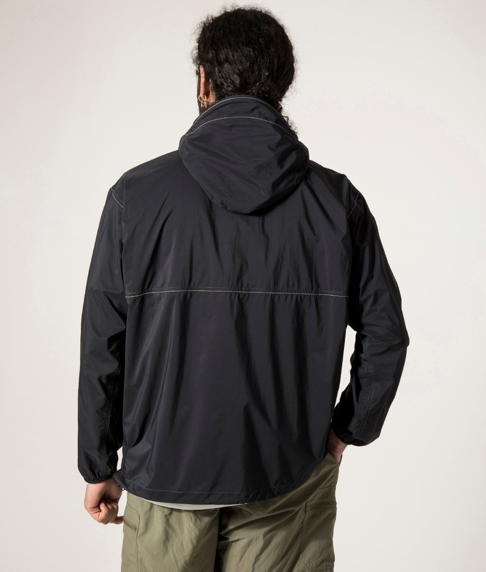 and wander Pertex Wind Jacket in Black at EQVVS. Back Model Shot.