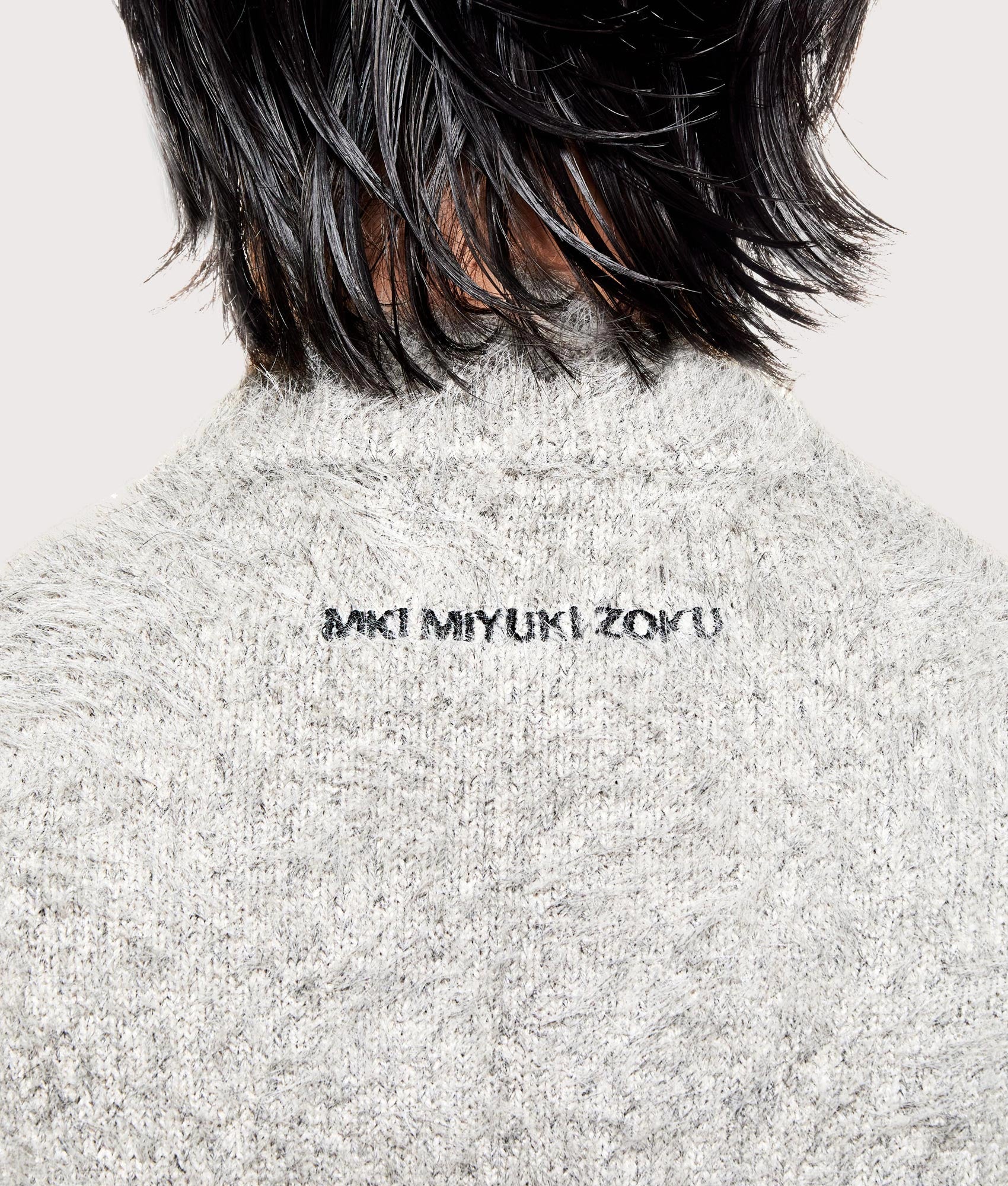 MKI MIYUKI ZOKU Faux Alpaca Knit Track Jacket in Charcoal Melange at EQVVS Menswear. Detail shot.