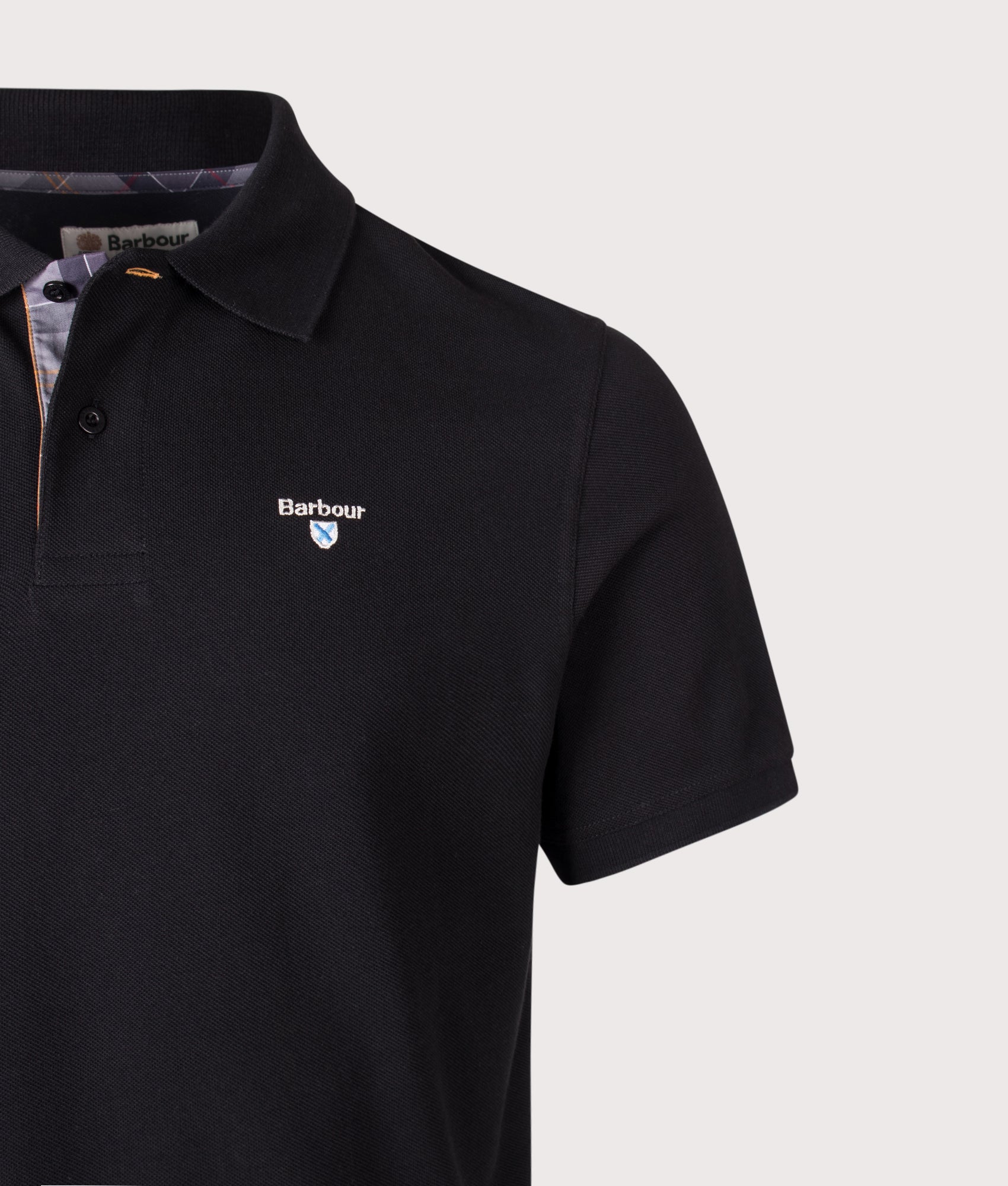 Barbour Lifestyle Tartan Pique Polo Shirt in Black at EQVVS Menswear. Detail shot.