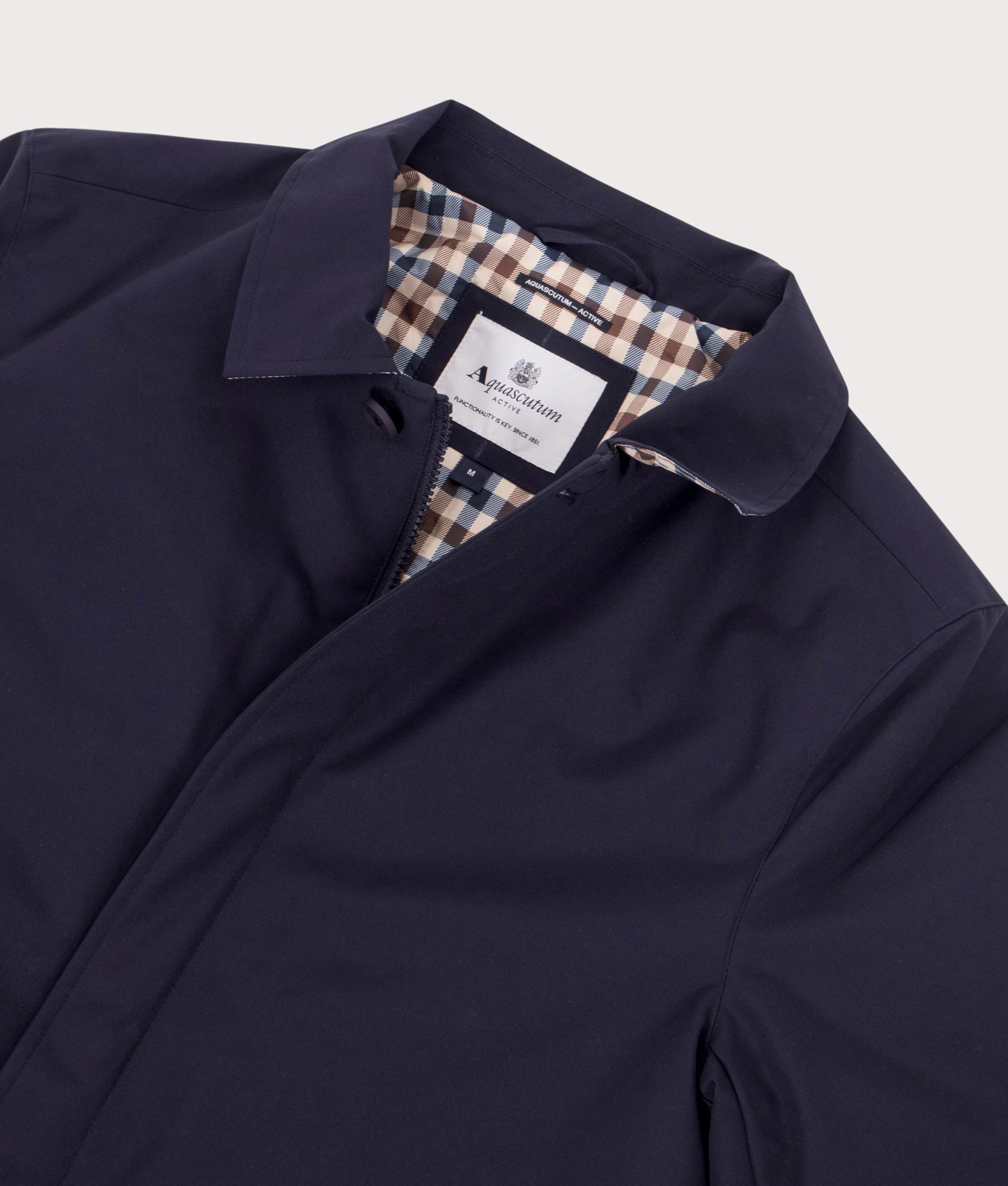 100% Polyester Active Shell Trench Coat in Navy by Aquascutum. Shot at EQVVS. Detail shot.