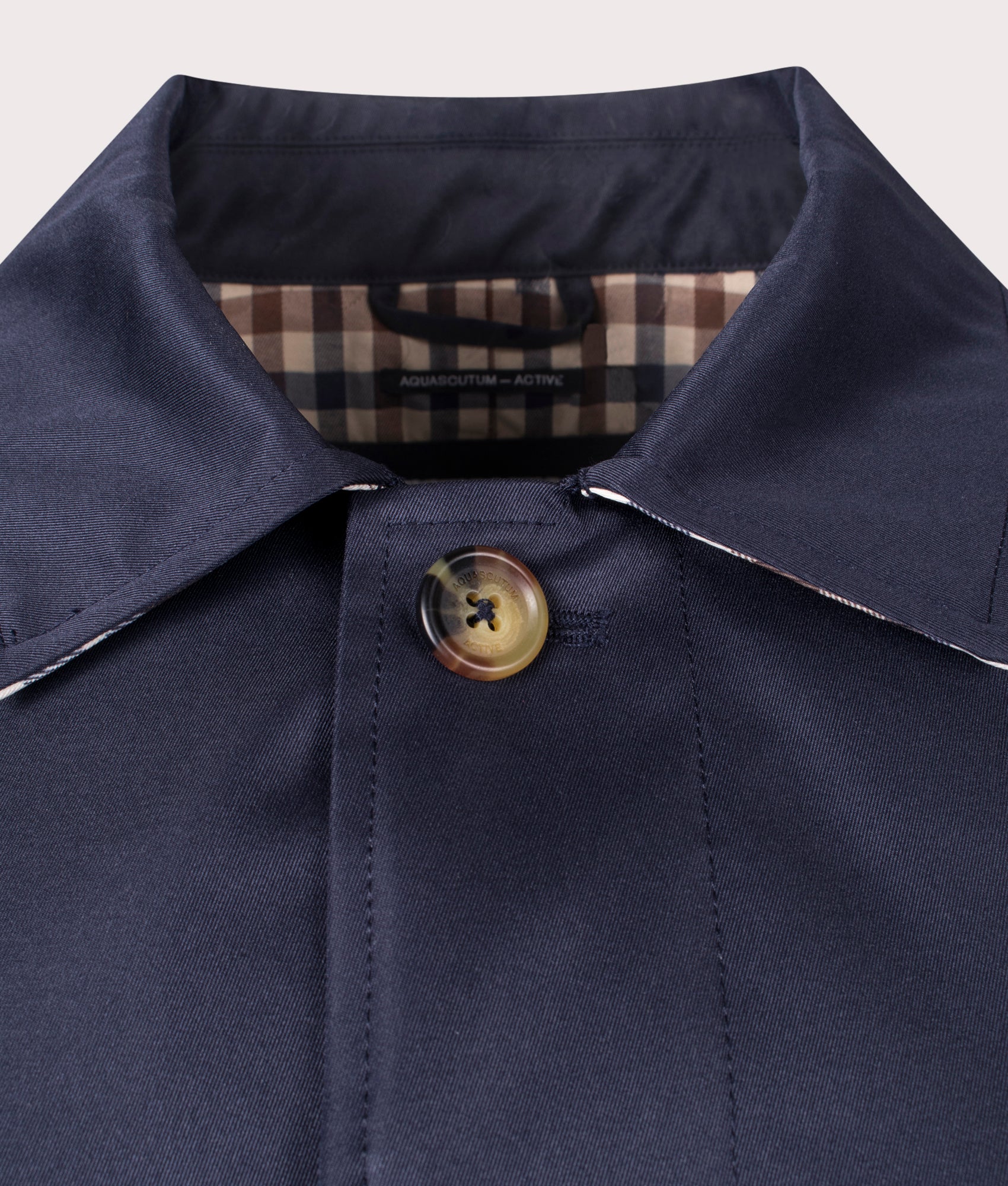 Aquascutum Iconic Caban Mac in Navy at EQVVS. Detailed button shot.