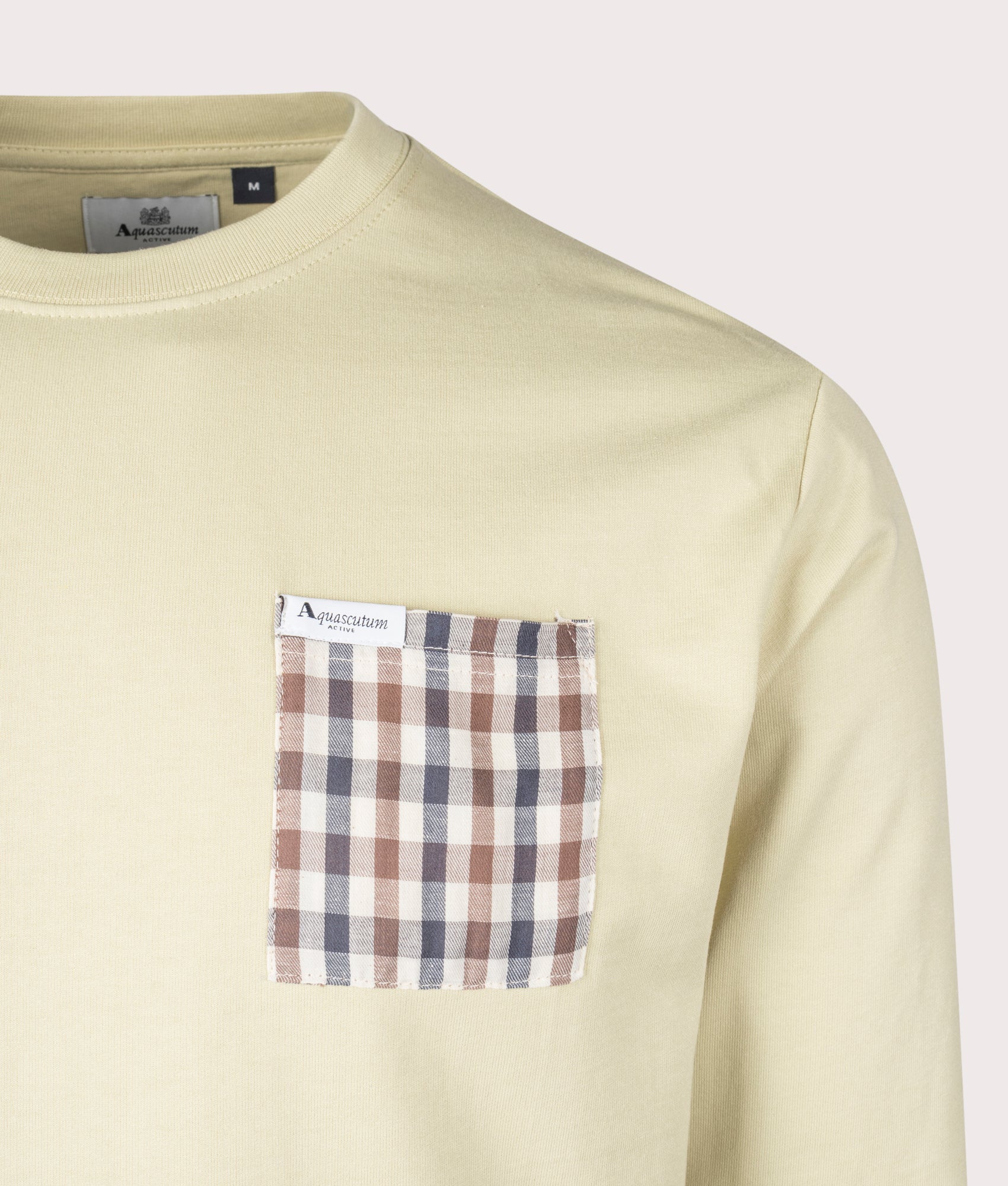 Aquascutum Iconic Pocket Crewneck Sweatshirt in Beige, 100% Cotton at EQVVS. Detailed logo shot. 