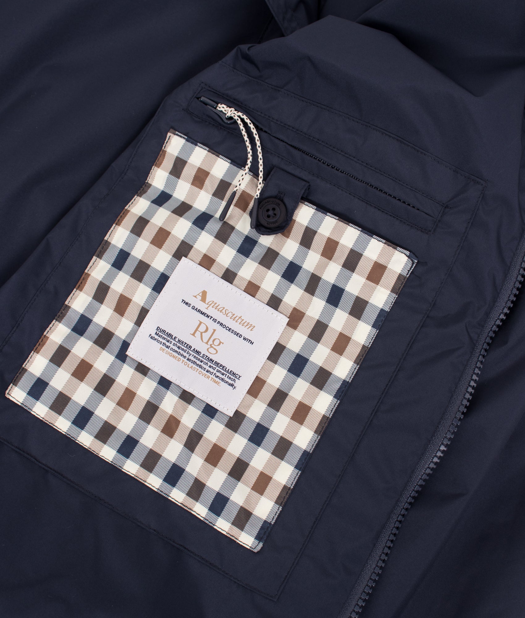 Aquascutum RLG Badge Packable Trench Coat in Navy at EQVVS Menswear. Internal detail shot.