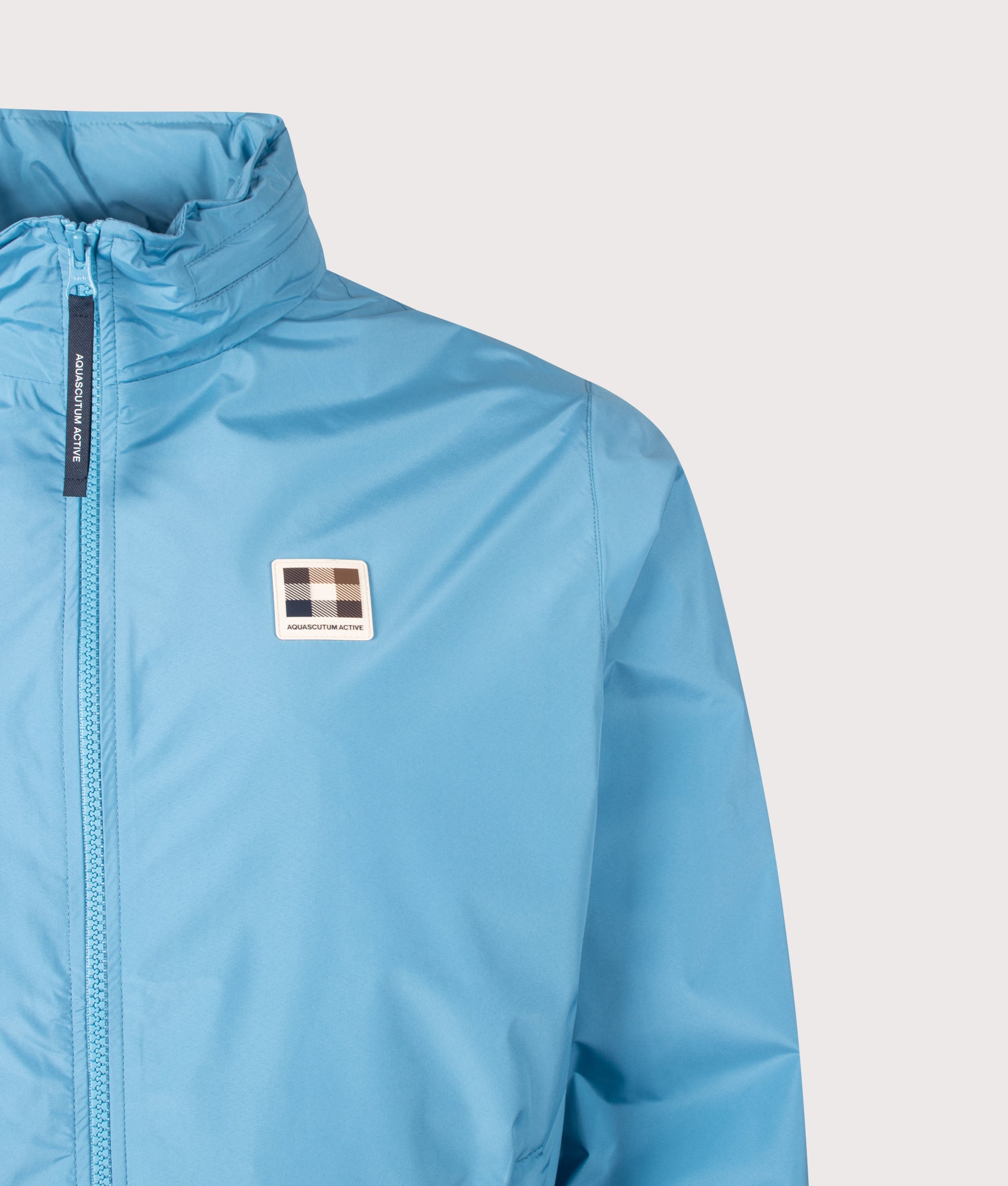 Aquascutum RLG Badge Windbreaker in Avio at EQVVS Menswear. Badge detail shot.