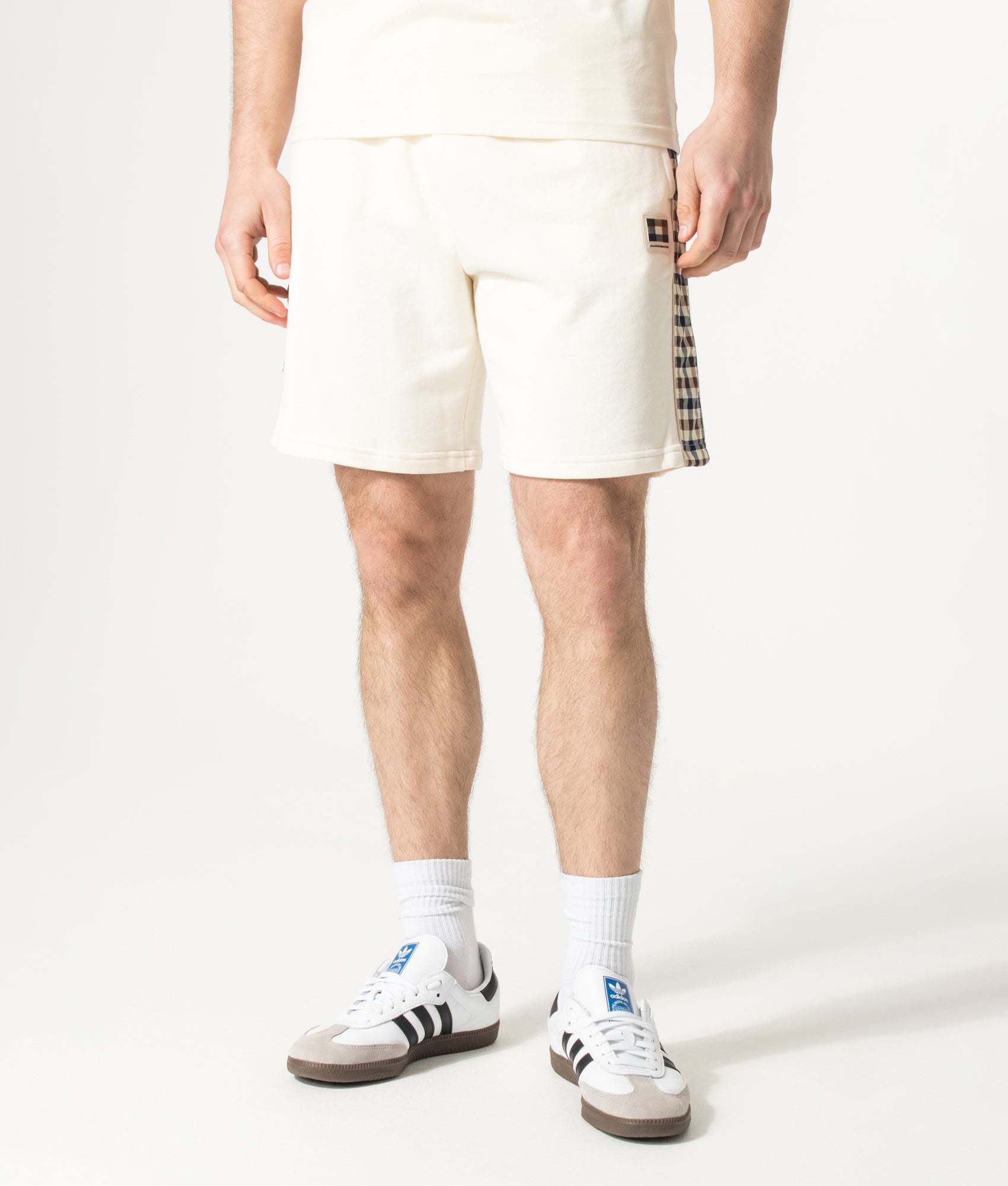 Aquascutum Lamina Insert Sweat Shorts in Old White at EQVVS Menswear. Angled model front shot.