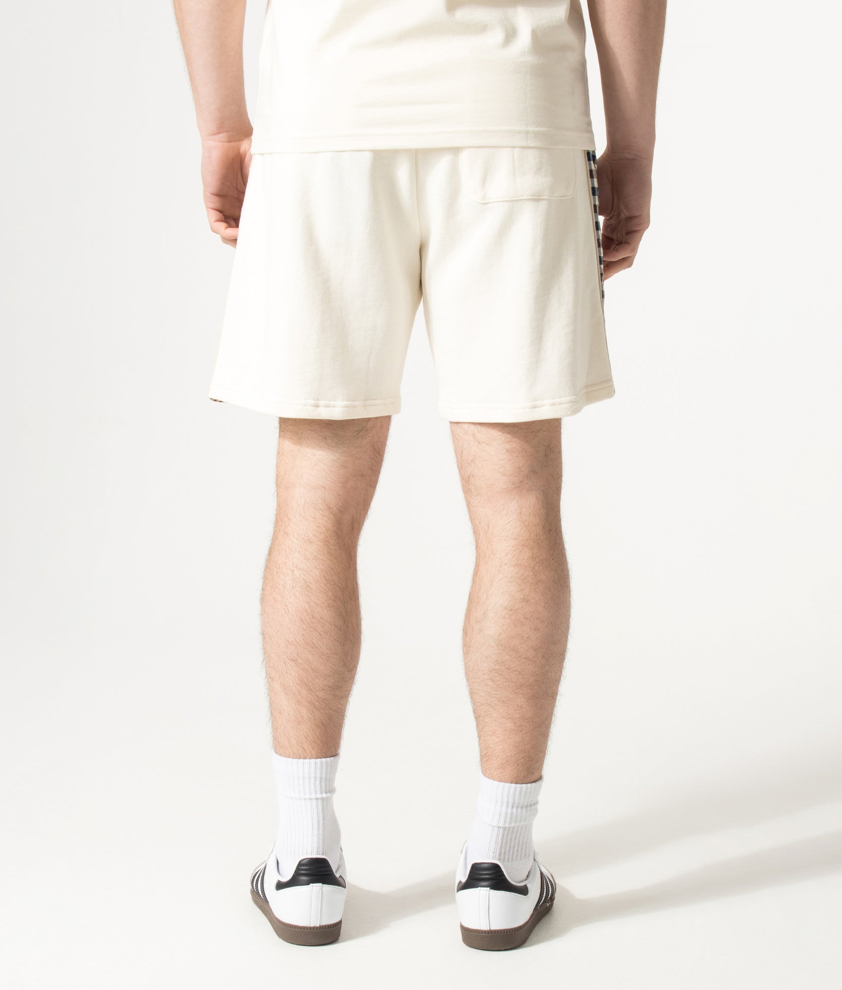 Aquascutum Lamina Insert Sweat Shorts in Old White at EQVVS Menswear. Model back shot.