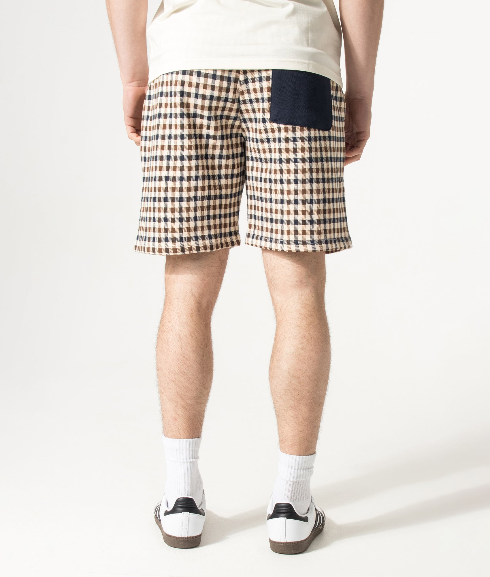 Aquascutum Club Check Sweat Shorts in Navy and Club Check at EQVVS Menswear. Model back shot.