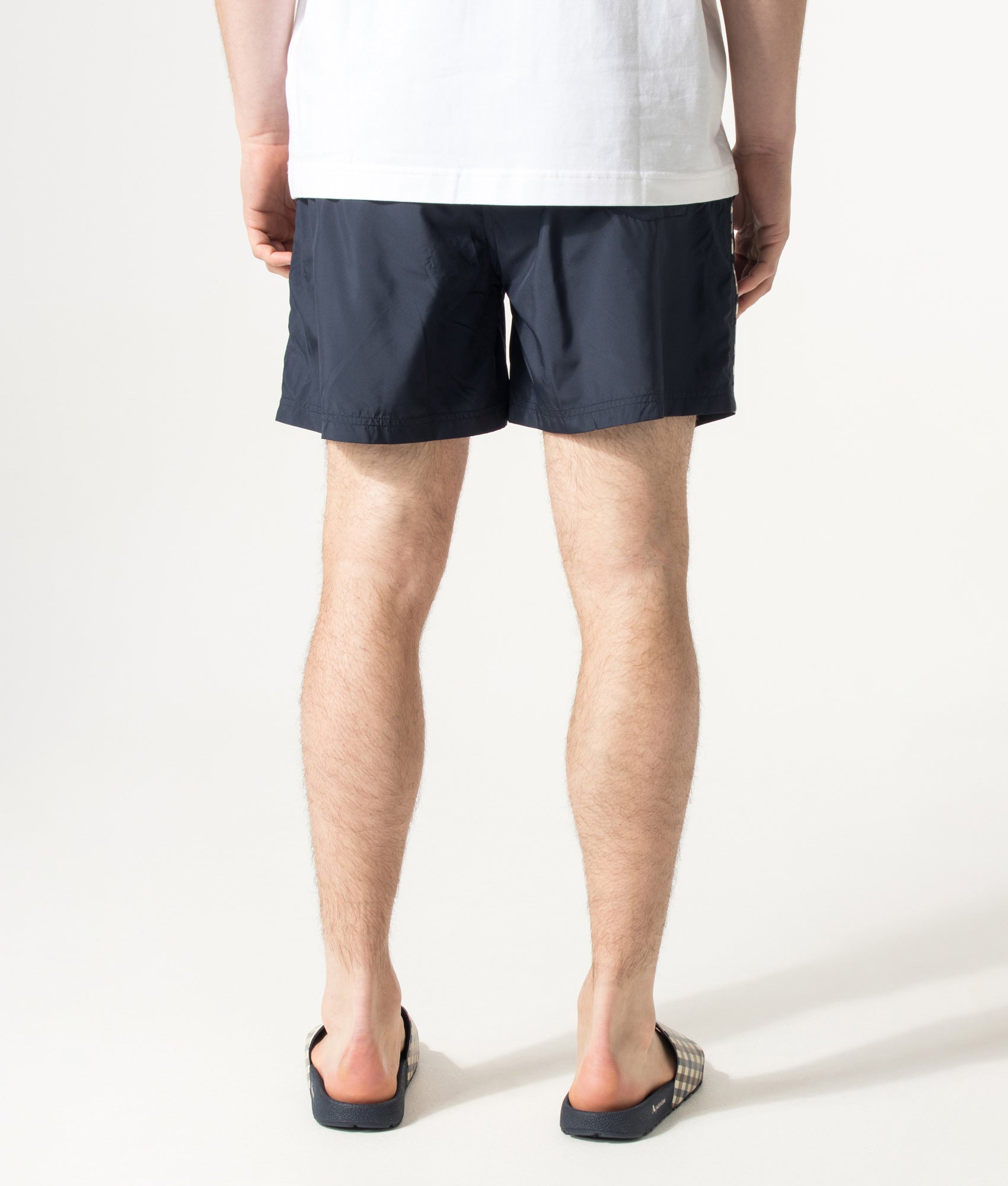 Aquascutum Club Check Piping Beach Swim Shorts in Navy at EQVVS Menswear. Model back shot.