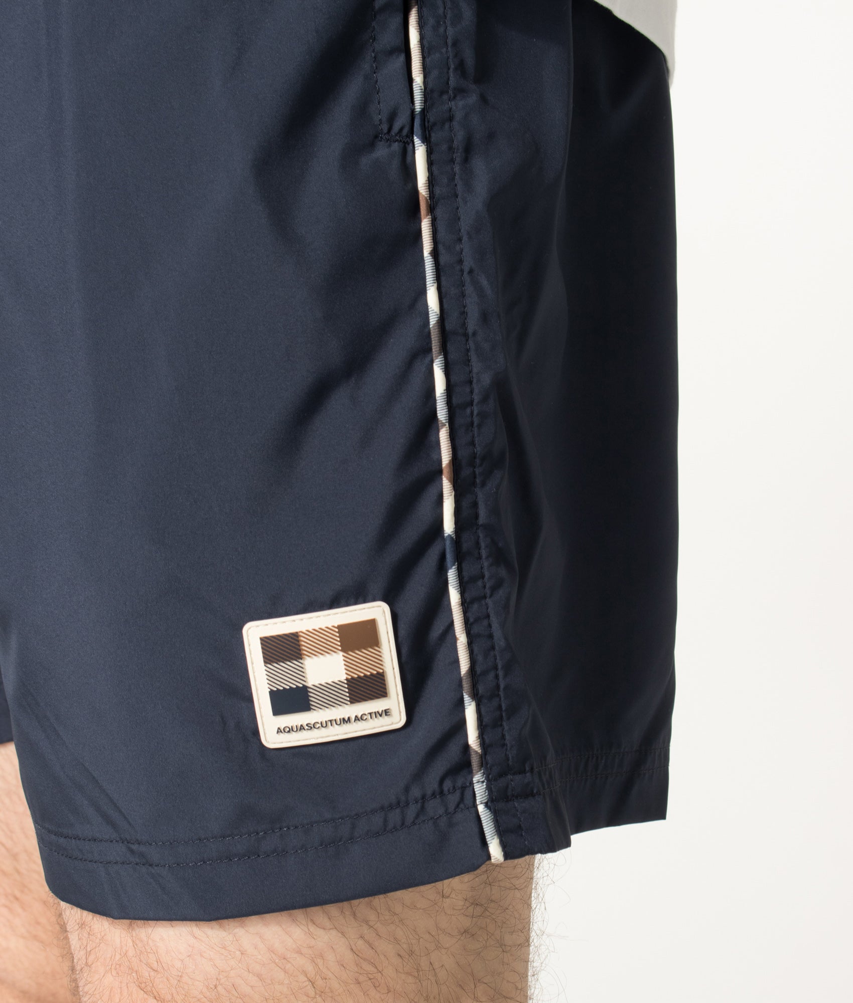 Aquascutum Club Check Piping Beach Swim Shorts in Navy at EQVVS Menswear. Detail shot.
