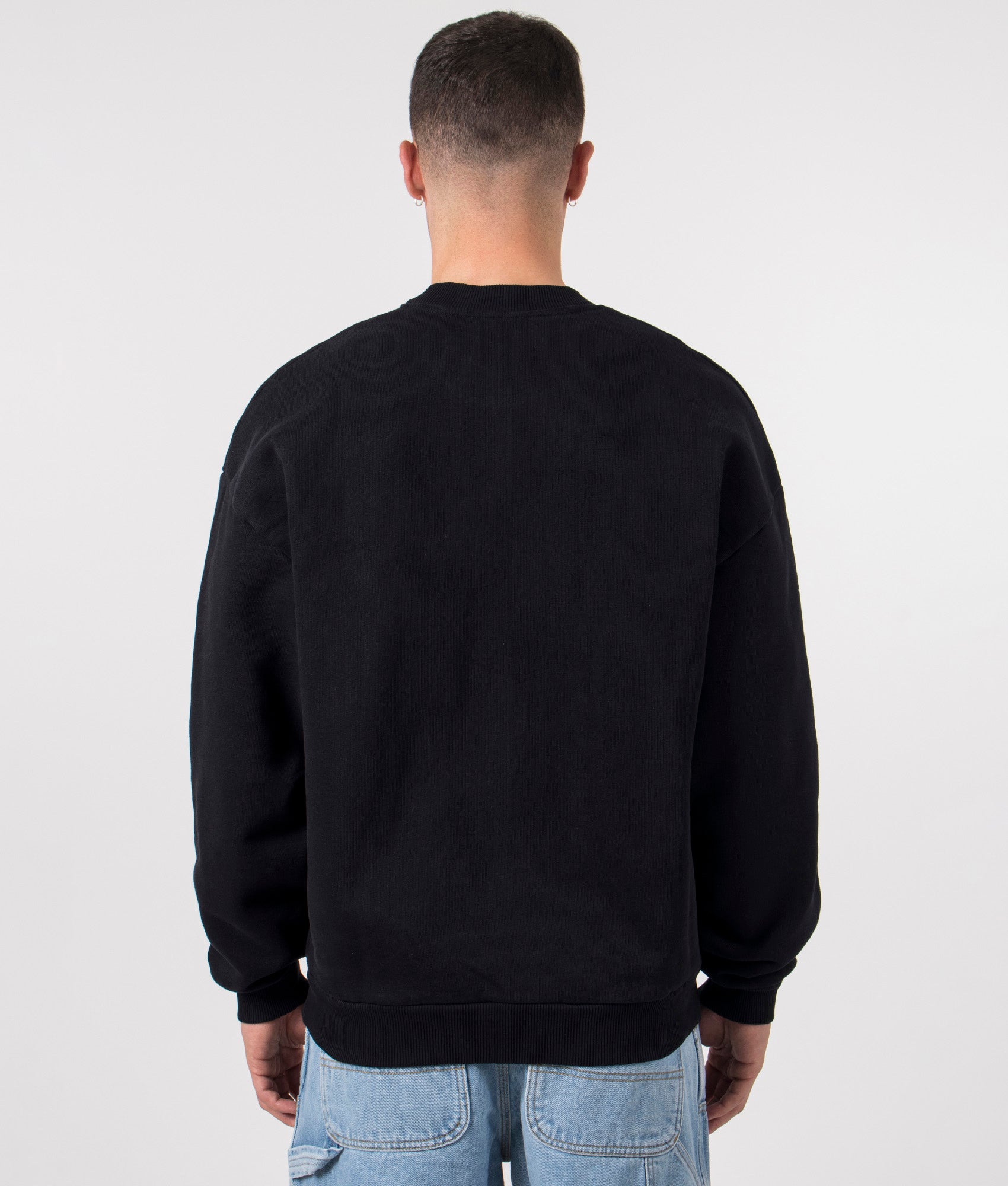 MKI MIYUKI ZOKU Oversized Uniform Crewneck Sweatshirt in Black at EQVVS Menswear. Model back shot.