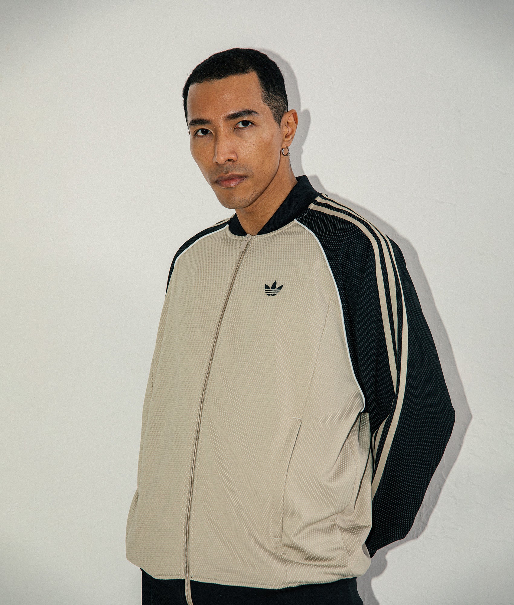 adidas Originals SST Track Top in Stone Khaki at EQVVS Menswear. Model shot.