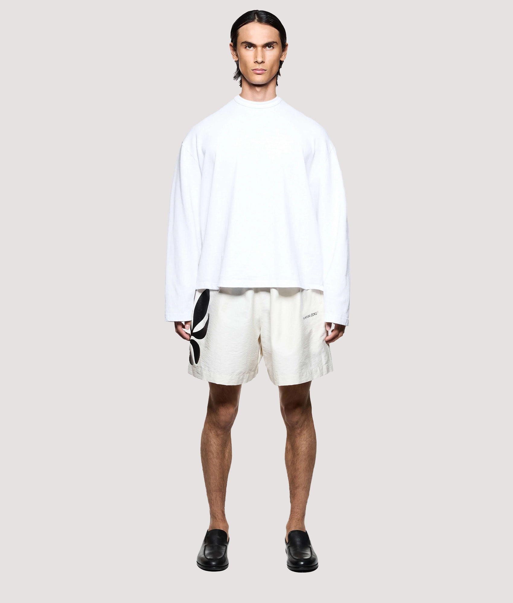 MKI MIYUKI ZOKU Relaxed Fit Botanical Print Wide Leg Shorts in Bone at EQVVS Menswear. Model front shot.
