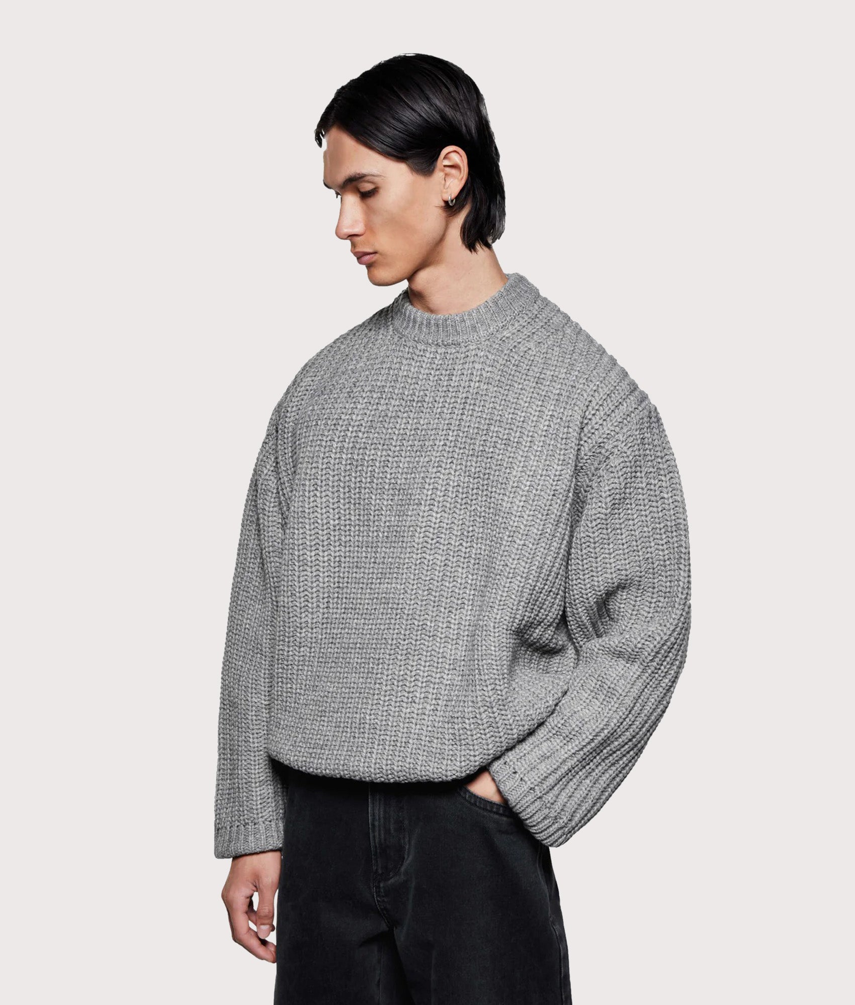 MKI MIYUKI ZOKU Oversized Chunky Rib Knit Crewneck Jumper in Grey Melange at EQVVS Menswear. Angled model front shot.