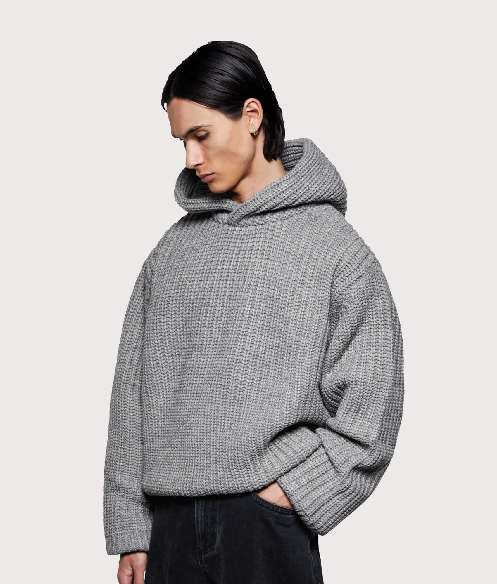 MKI MIYUKI ZOKU Oversized Chunky Ribbed Knit Hoodie in Grey Melange at EQVVS Menswear. Angled model front shot.