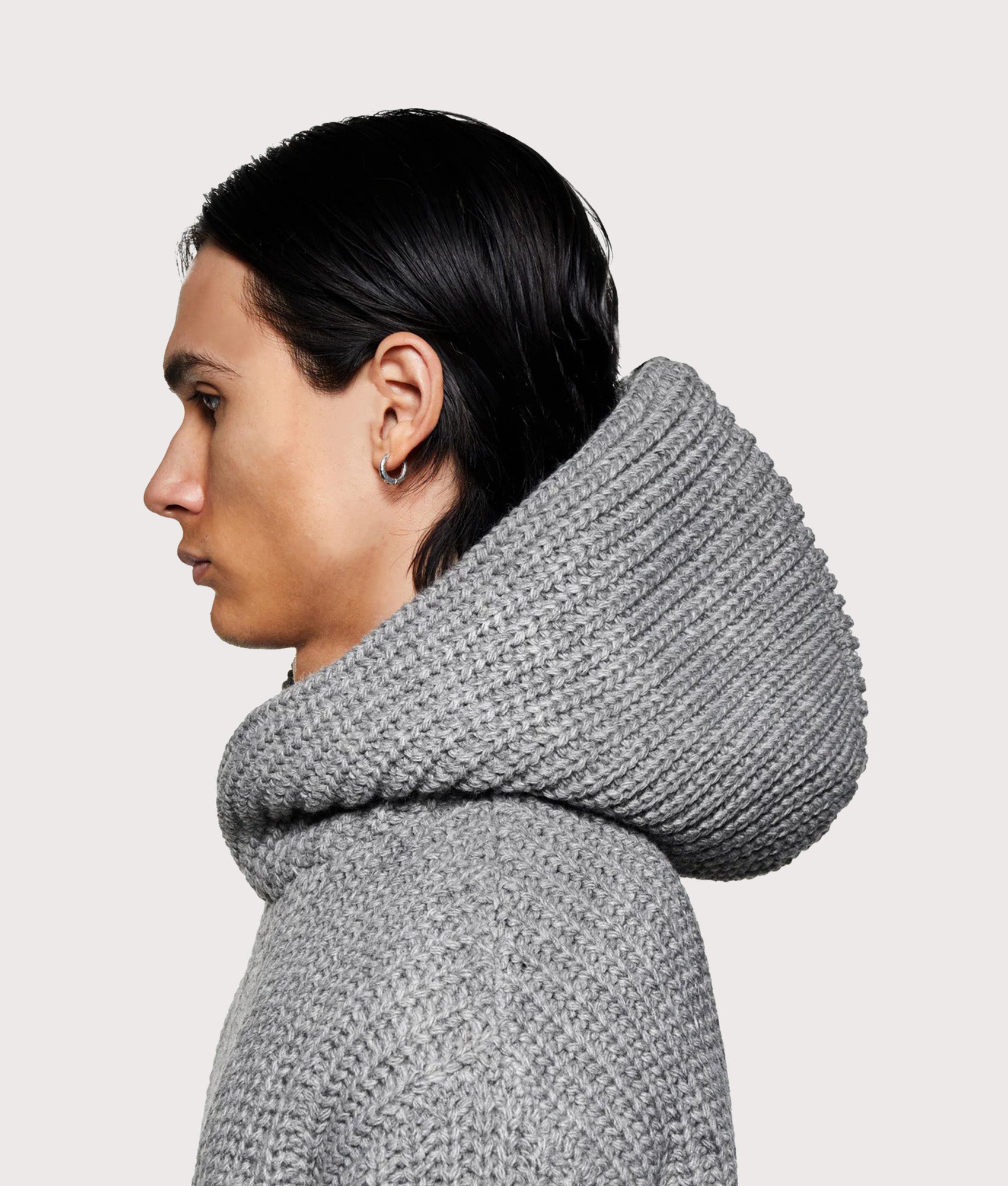MKI MIYUKI ZOKU Oversized Chunky Ribbed Knit Hoodie in Grey Melange at EQVVS Menswear. Model side hood shot.