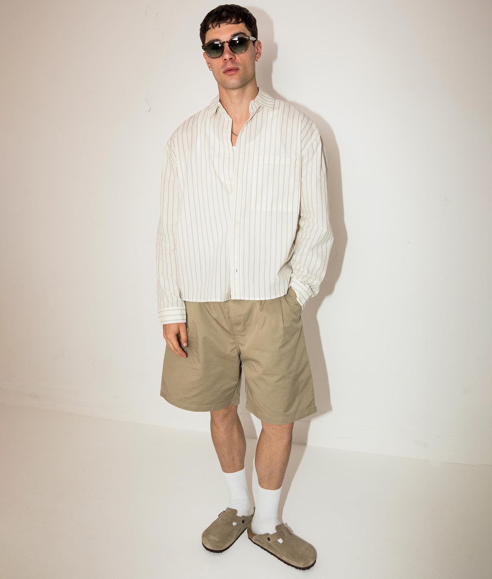 MKI MIYUKI ZOKU Box Fit Seersucker Stripe Dress Shirt in Off White at EQVVS Menswear. Campaign shot.