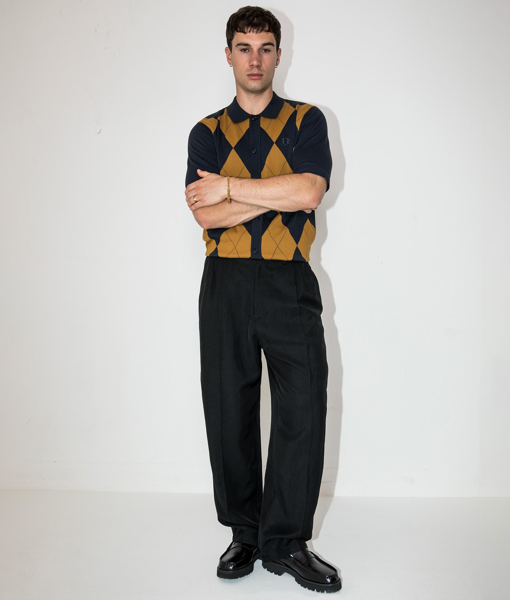 Fred Perry Argyle Button Through Knitted Shirt in Navy at EQVVS Menswear. Campaign shot.