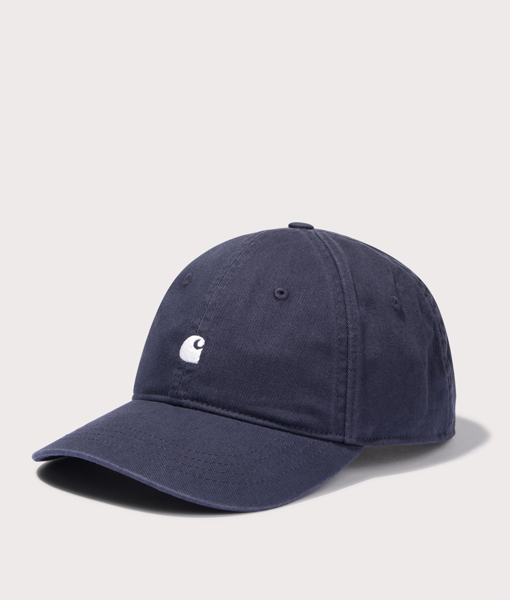 Carhartt WIP Madison Logo Cap in Dark Navy/Wax. Side angle shot at EQVVS.