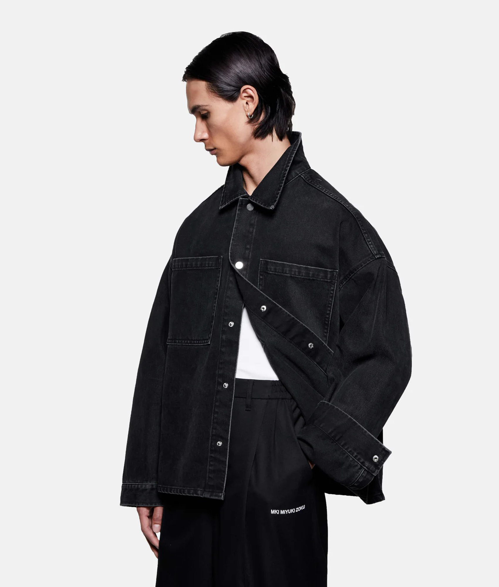 MKI MIYUKI ZOKU Denim Box Overshirt in Black Wash at EQVVS Menswear.  Angled model front shot.