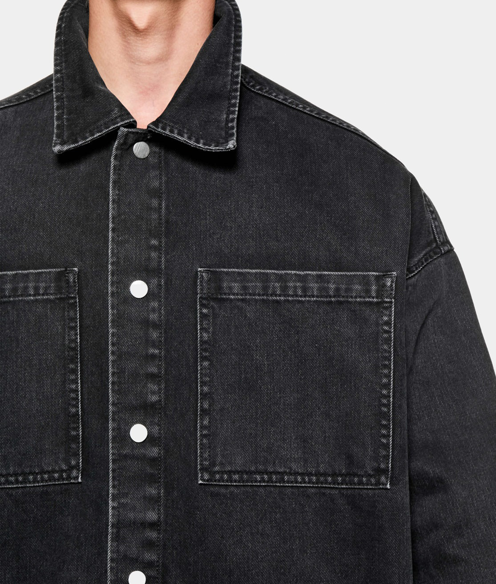 MKI MIYUKI ZOKU Denim Box Overshirt in Black Wash at EQVVS Menswear.  Model detail shot.