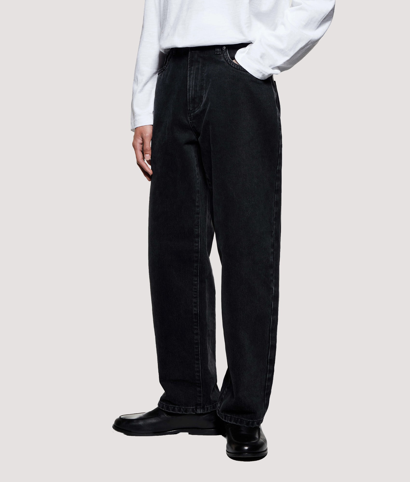 MKI MIYUKI ZOKU Denim Classic Jeans in Black Wash at EQVVS Menswear.  Angled model front shot.