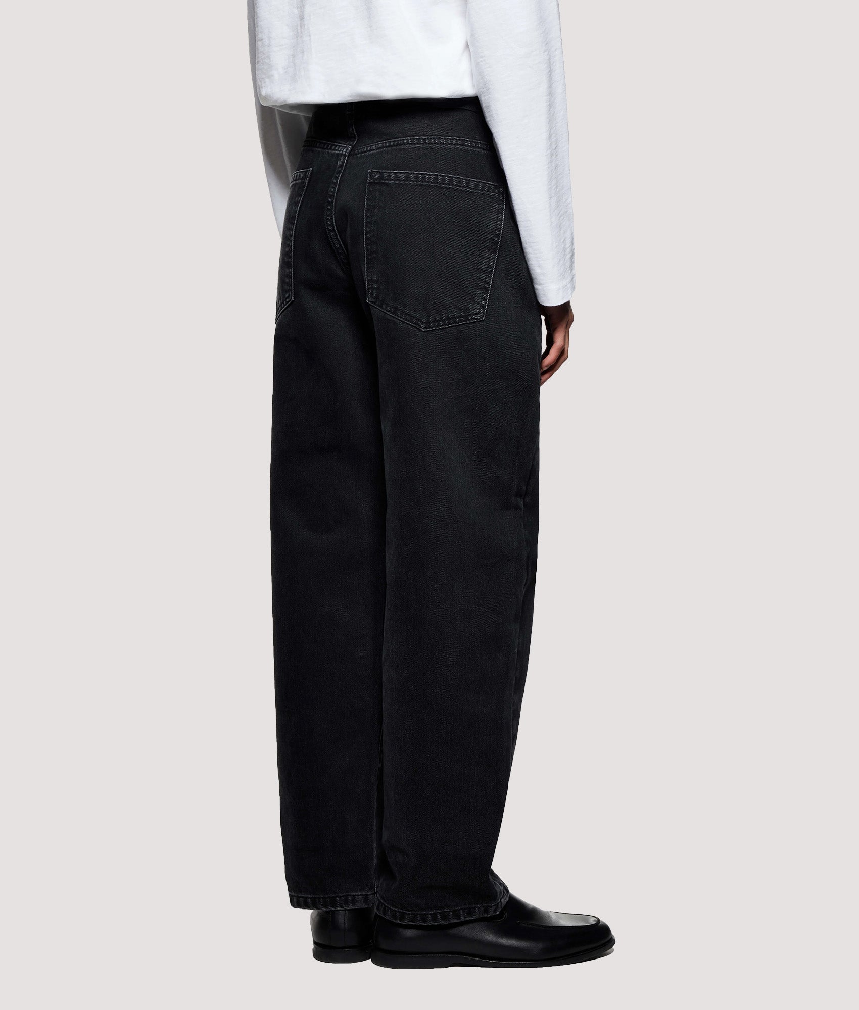 MKI MIYUKI ZOKU Denim Classic Jeans in Black Wash at EQVVS Menswear. Angled back shot.