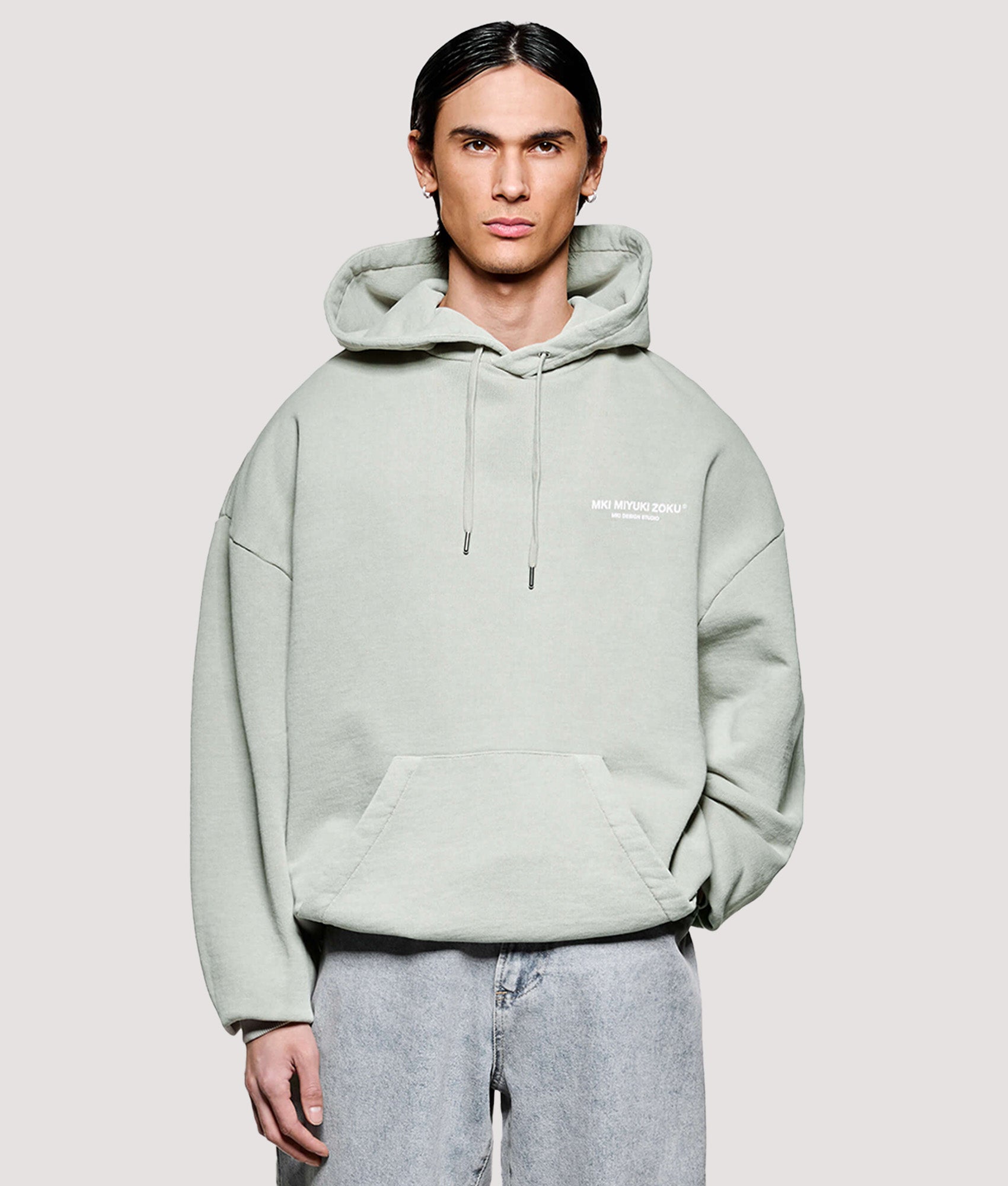 MKI MIYUKI ZOKU Box Fit Design Studio Hoodie in Pigment Cement at EQVVS Menswear. Model front shot.