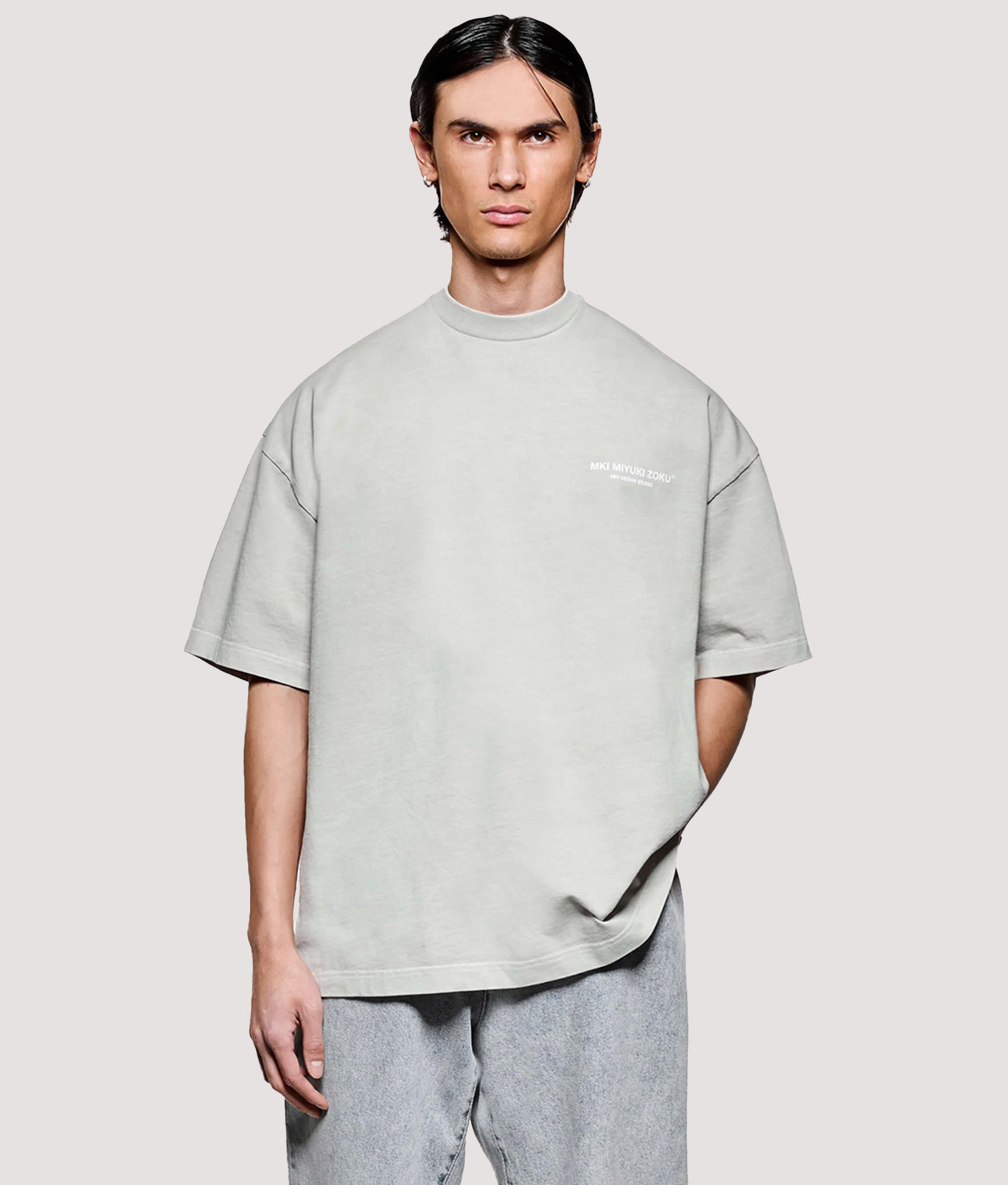 MKI MIYUKI ZOKU Box Fit Design Studio T-Shirt in Pigment Cement at EQVVS Menswear. Model front shot.