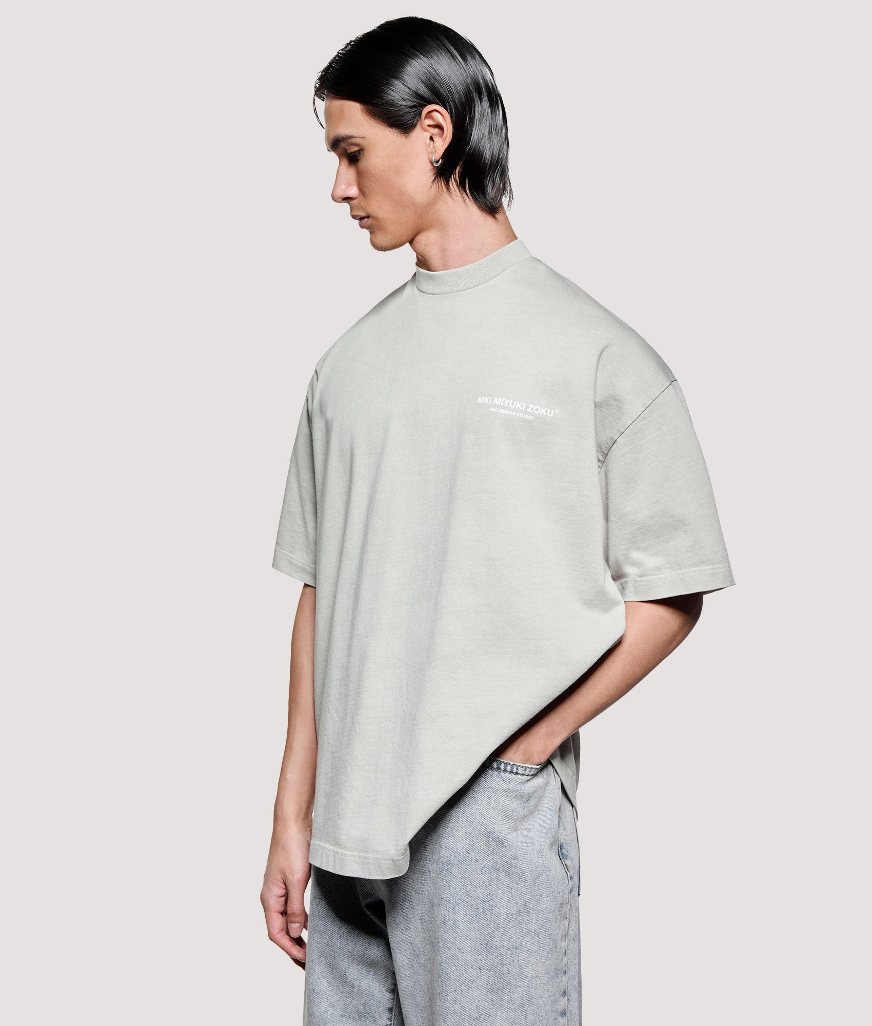 MKI MIYUKI ZOKU Box Fit Design Studio T-Shirt in Pigment Cement at EQVVS Menswear. Angled model front shot.