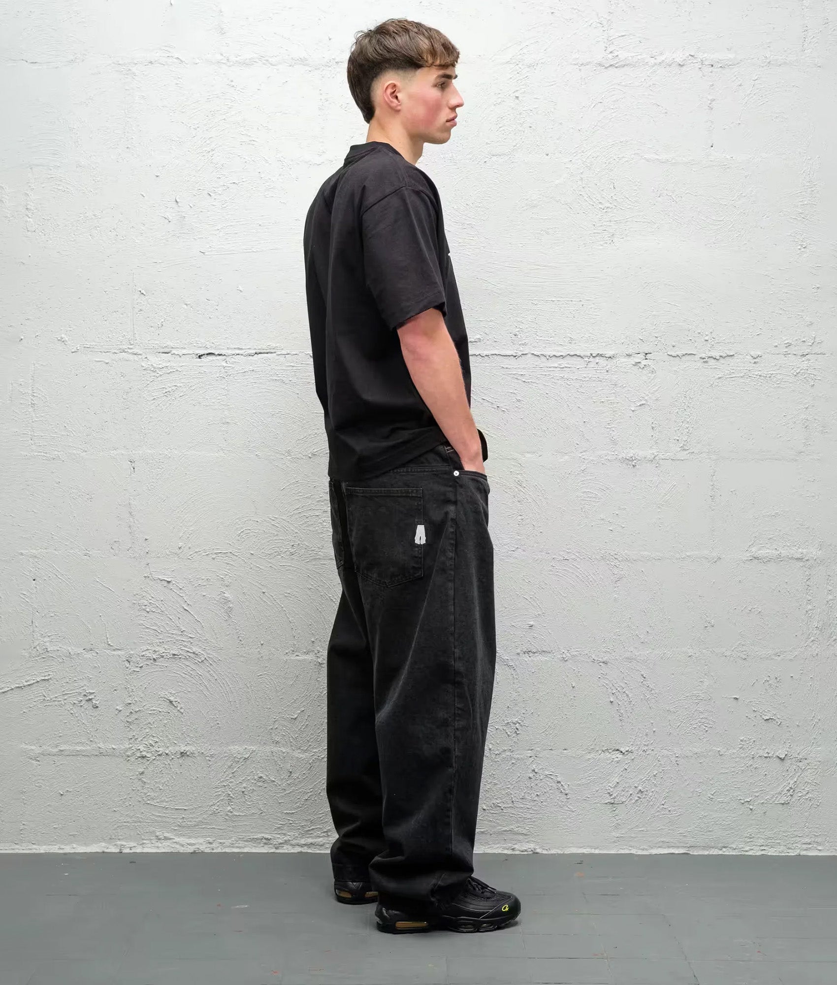 Baggys Baggy Denim Pants in Pitch Black at EQVVS Menswear. Model angled back shot.