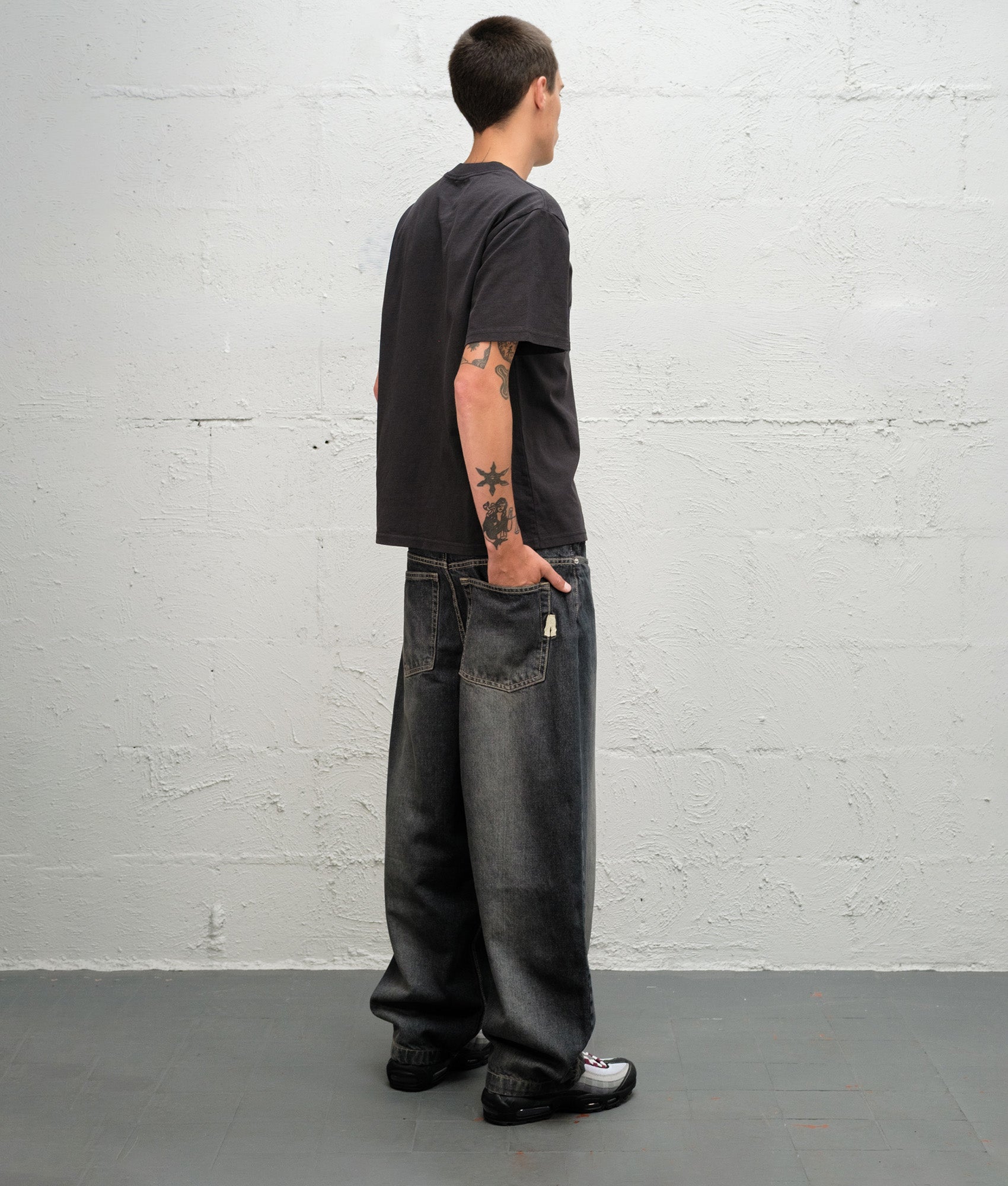 Baggys Baggy Denim Pants in Flint Grey at EQVVS Menswear. Model angled back shot.