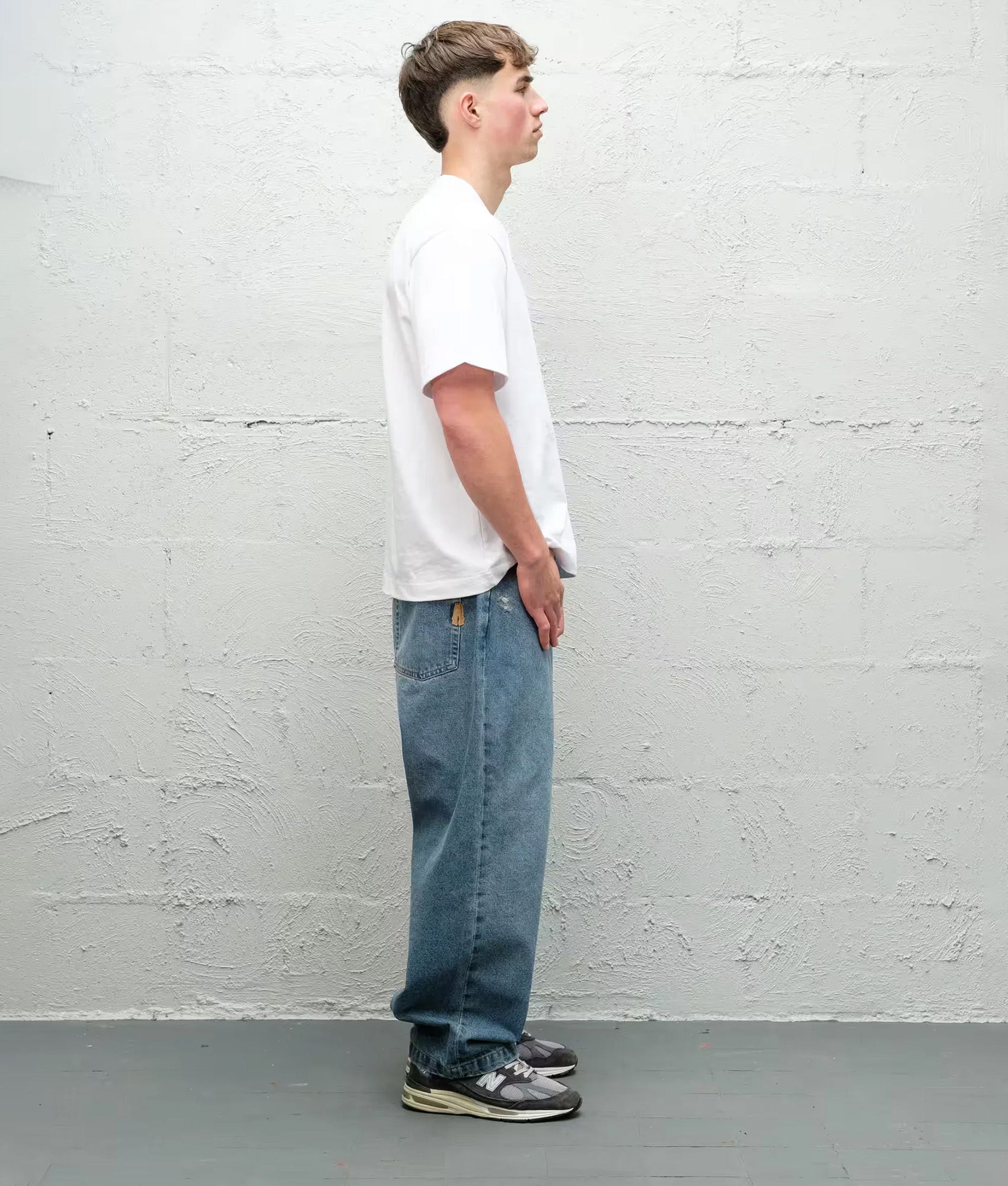 Baggys Baggy Denim Pants in Light Washed Fray at EQVVS Menswear. Model side shot.