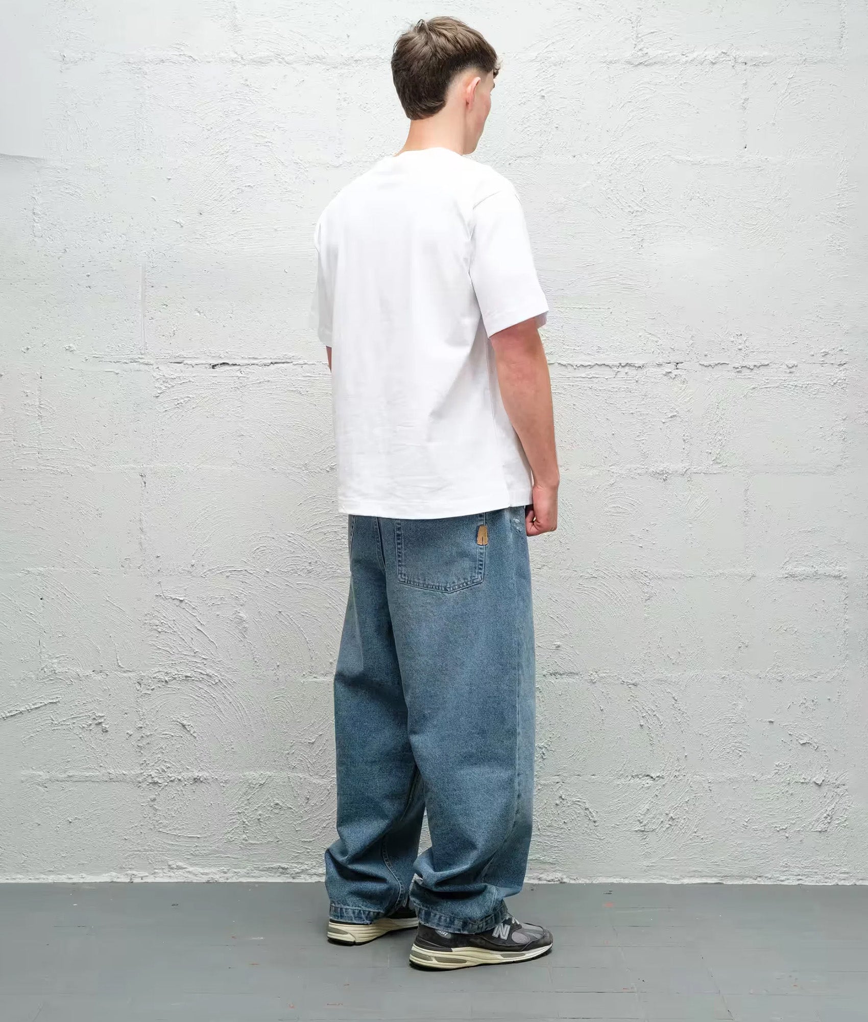 Baggys Baggy Denim Pants in Light Washed Fray at EQVVS Menswear. Model back shot.