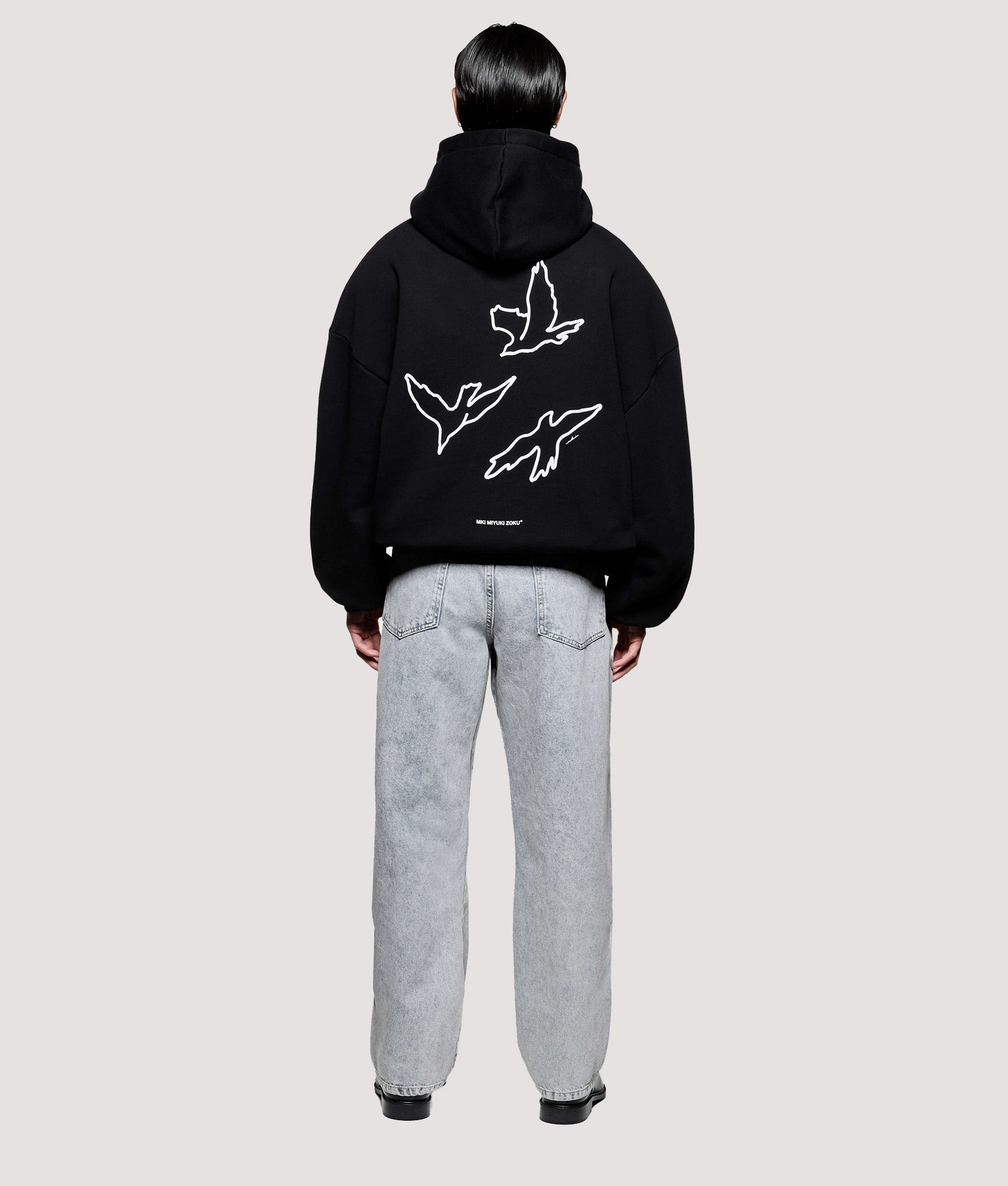 MKI MIYUKI ZOKU Box Fit Flight Hoodie in Black at EQVVS Menswear. Model back shot.