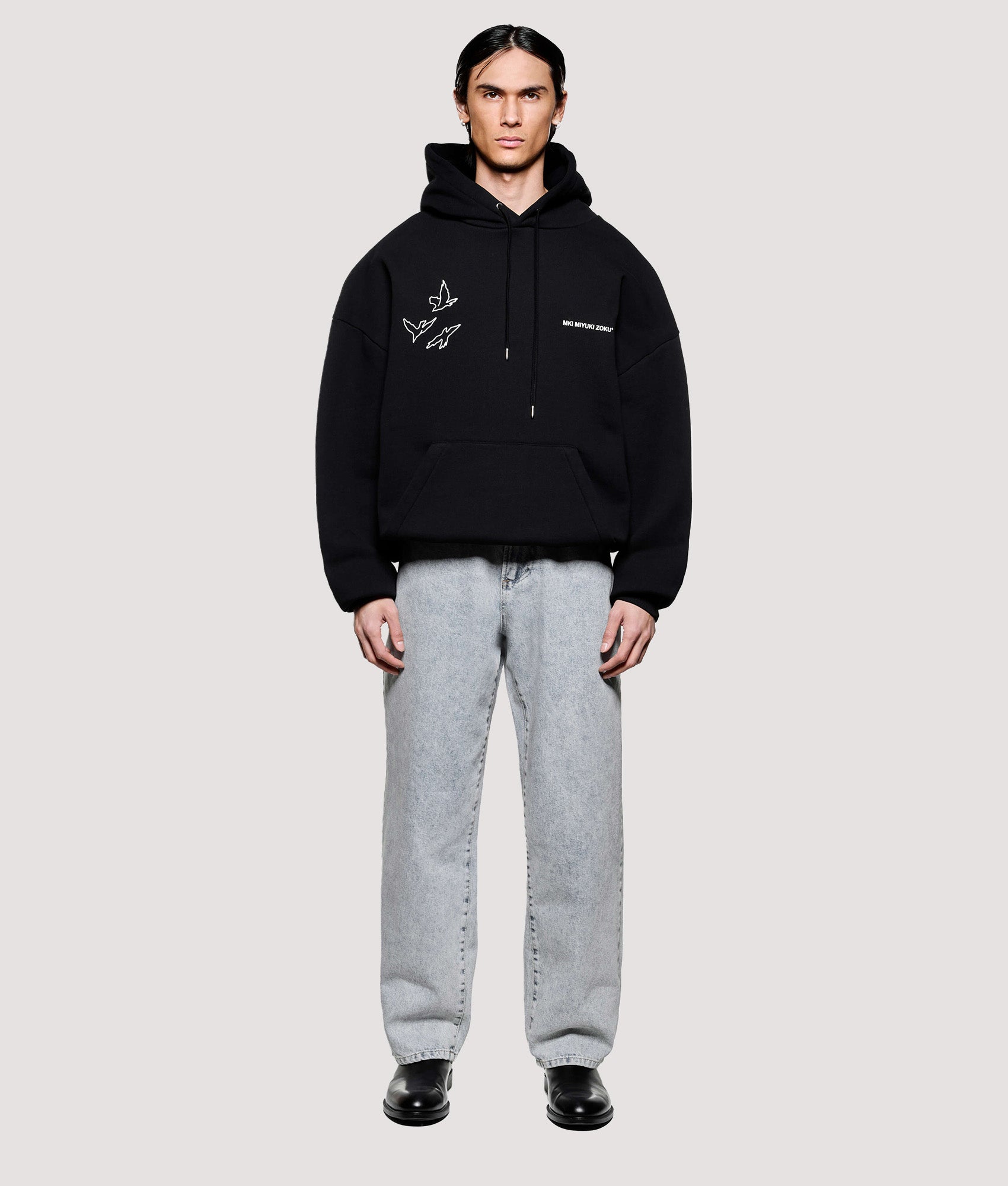 MKI MIYUKI ZOKU Box Fit Flight Hoodie in Black at EQVVS Menswear. Model front shot.