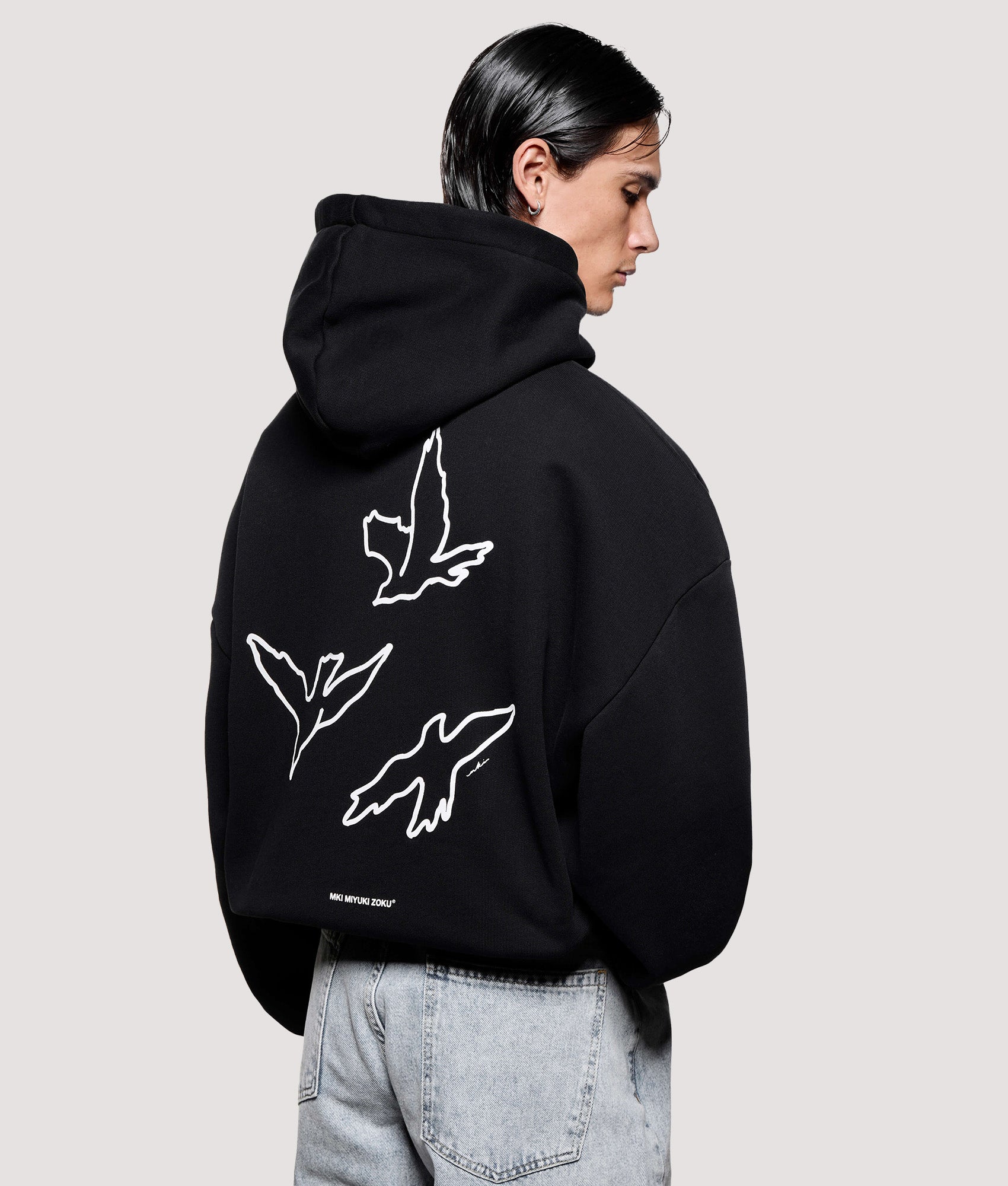 MKI MIYUKI ZOKU Box Fit Flight Hoodie in Black at EQVVS Menswear. Angled back shot.