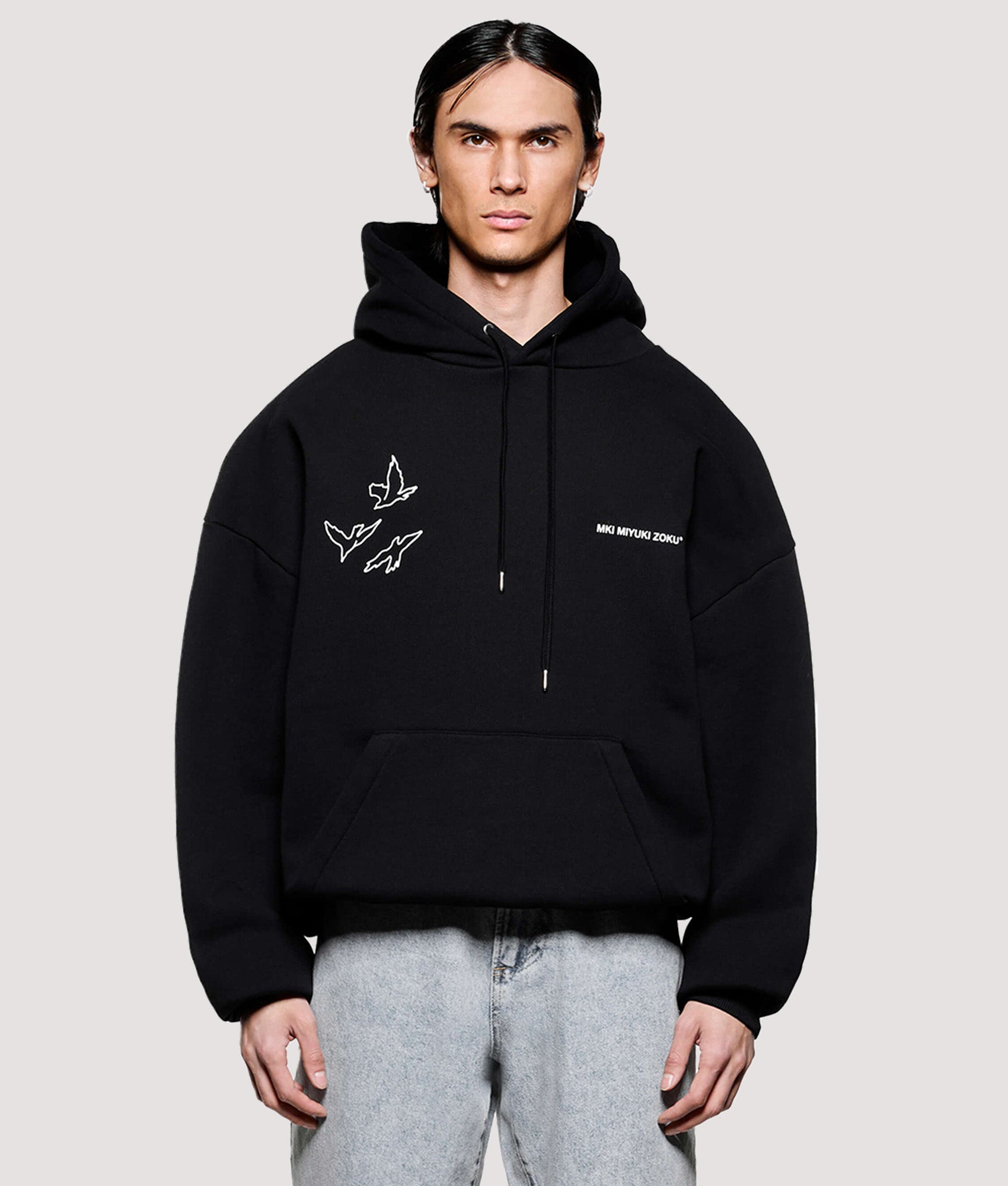 MKI MIYUKI ZOKU Box Fit Flight Hoodie in Black at EQVVS Menswear. Model front shot.