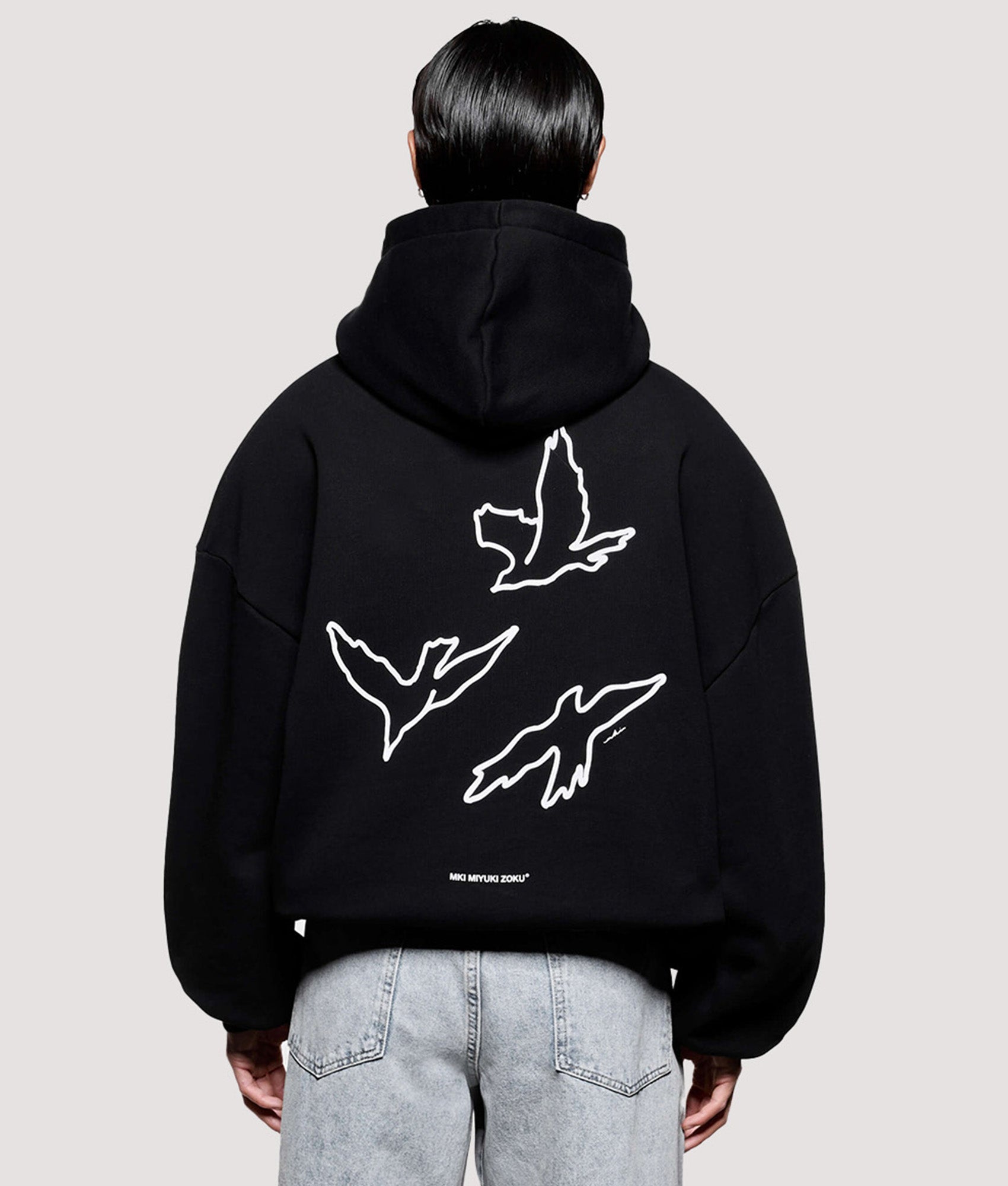 MKI MIYUKI ZOKU Box Fit Flight Hoodie in Black at EQVVS Menswear. Model back shot.