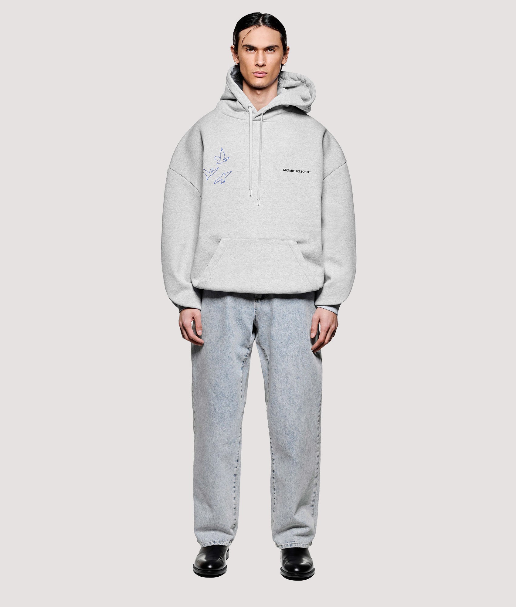MKI MIYUKI ZOKU Box Fit Flight Hoodie in Grey at EQVVS Menswear. Model full front shot.