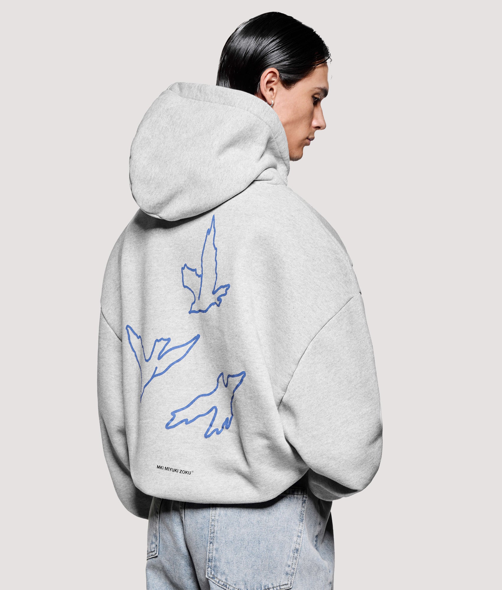 MKI MIYUKI ZOKU Box Fit Flight Hoodie in Grey at EQVVS Menswear. Angled back shot.