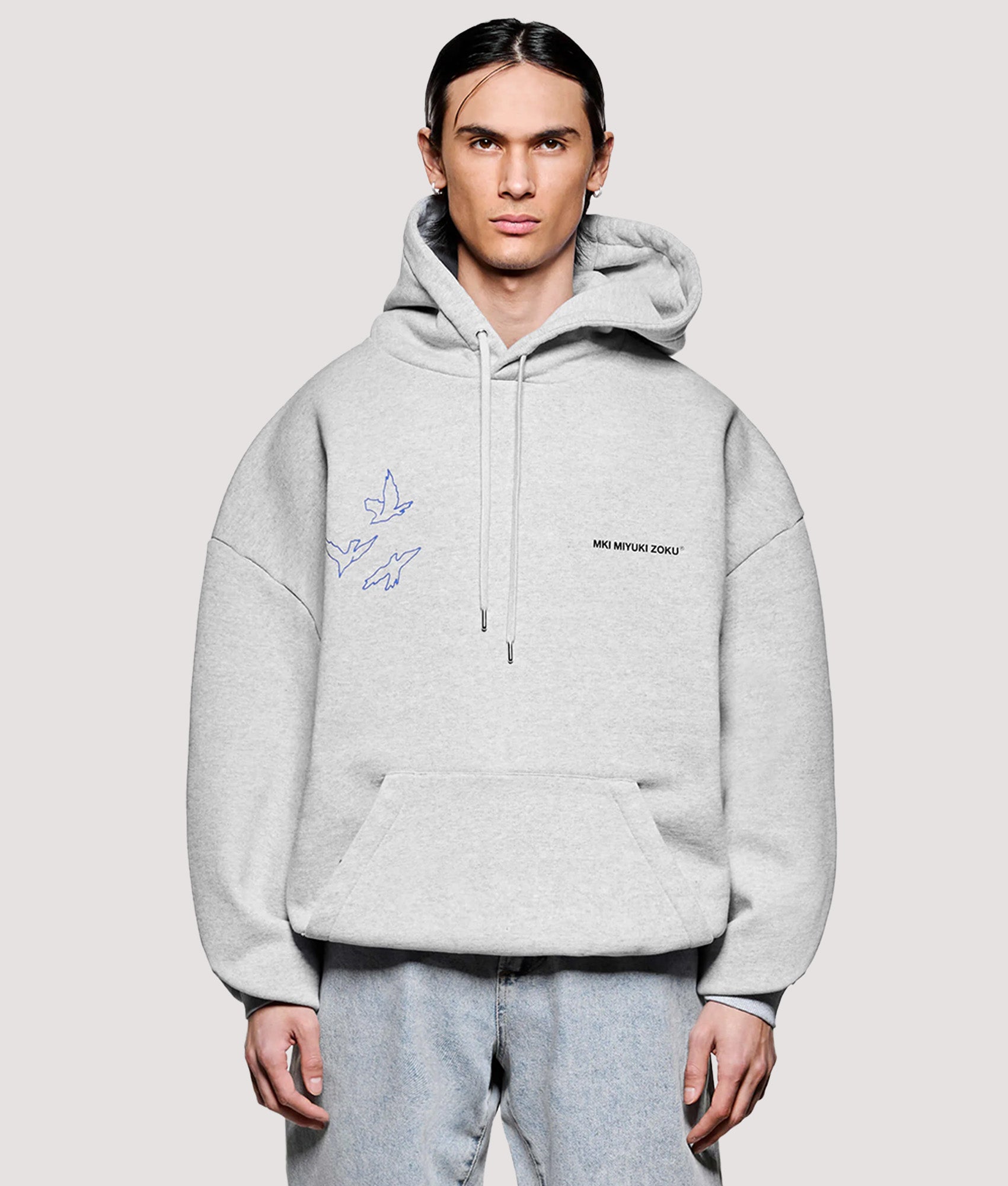 MKI MIYUKI ZOKU Box Fit Flight Hoodie in Grey at EQVVS Menswear. Model front shot.