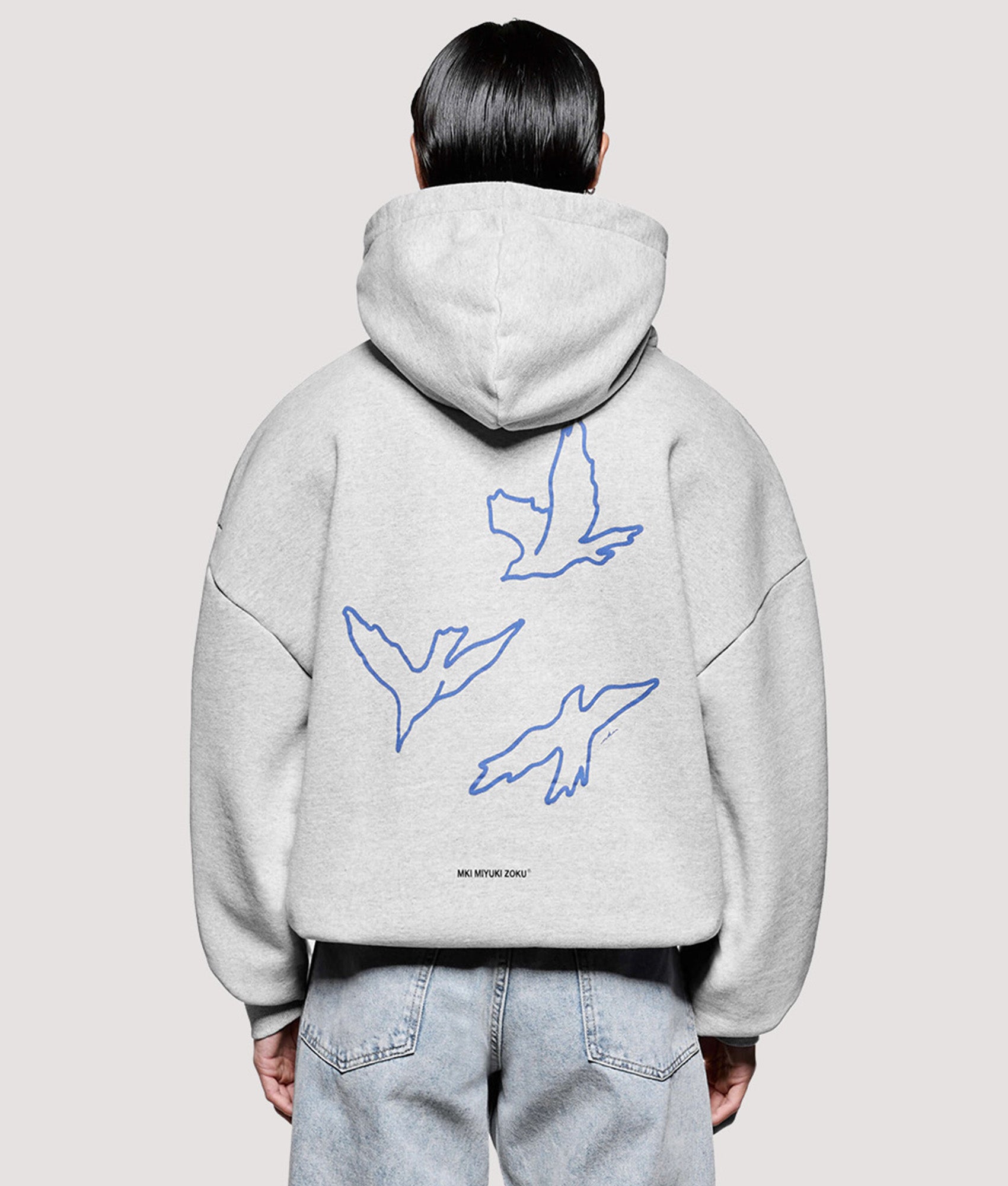 MKI MIYUKI ZOKU Box Fit Flight Hoodie in Grey at EQVVS Menswear. Model back shot. 