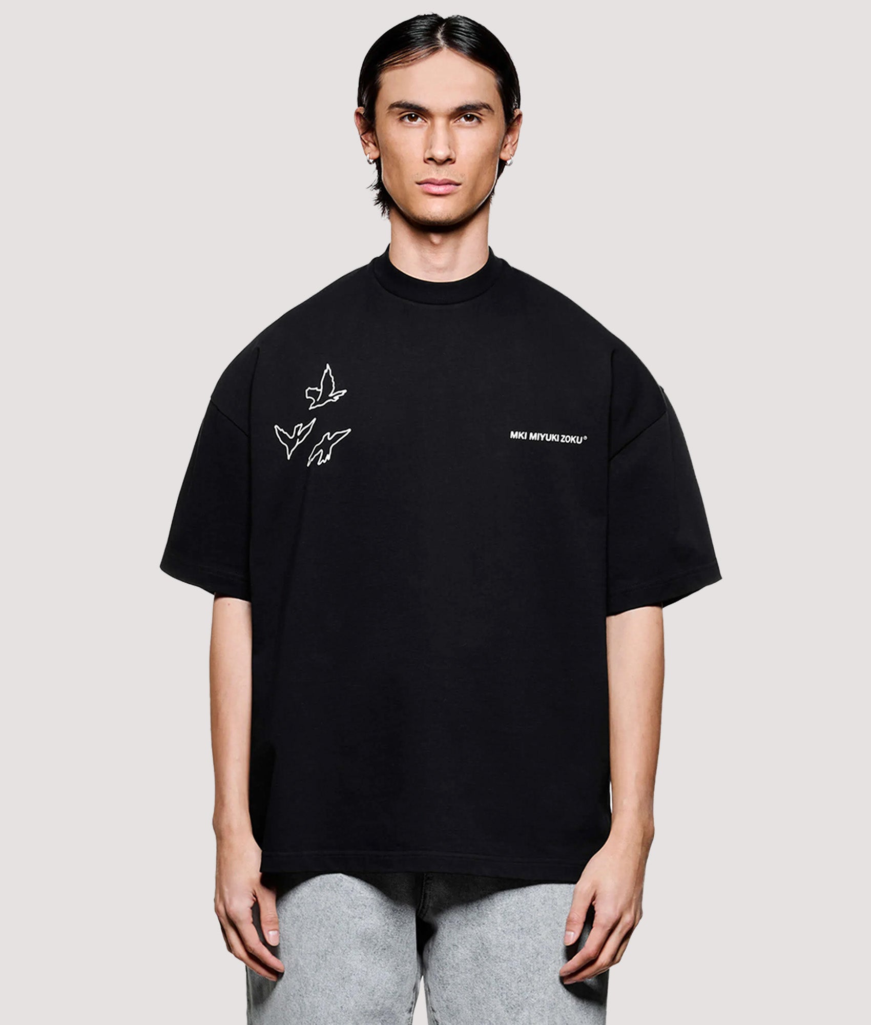MKI MIYUKI ZOKU Box Fit Flight T-Shirt in Black at EQVVS Menswear. Model front shot.