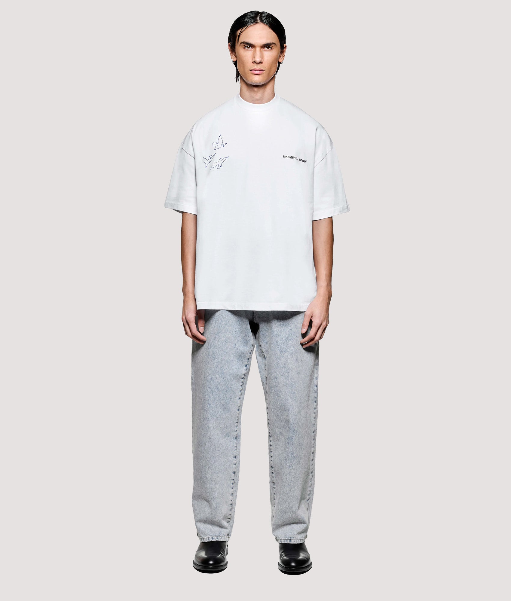 MKI MIYUKI ZOKU Box Fit Flight T-Shirt in White at EQVVS Menswear. Model front shot.
