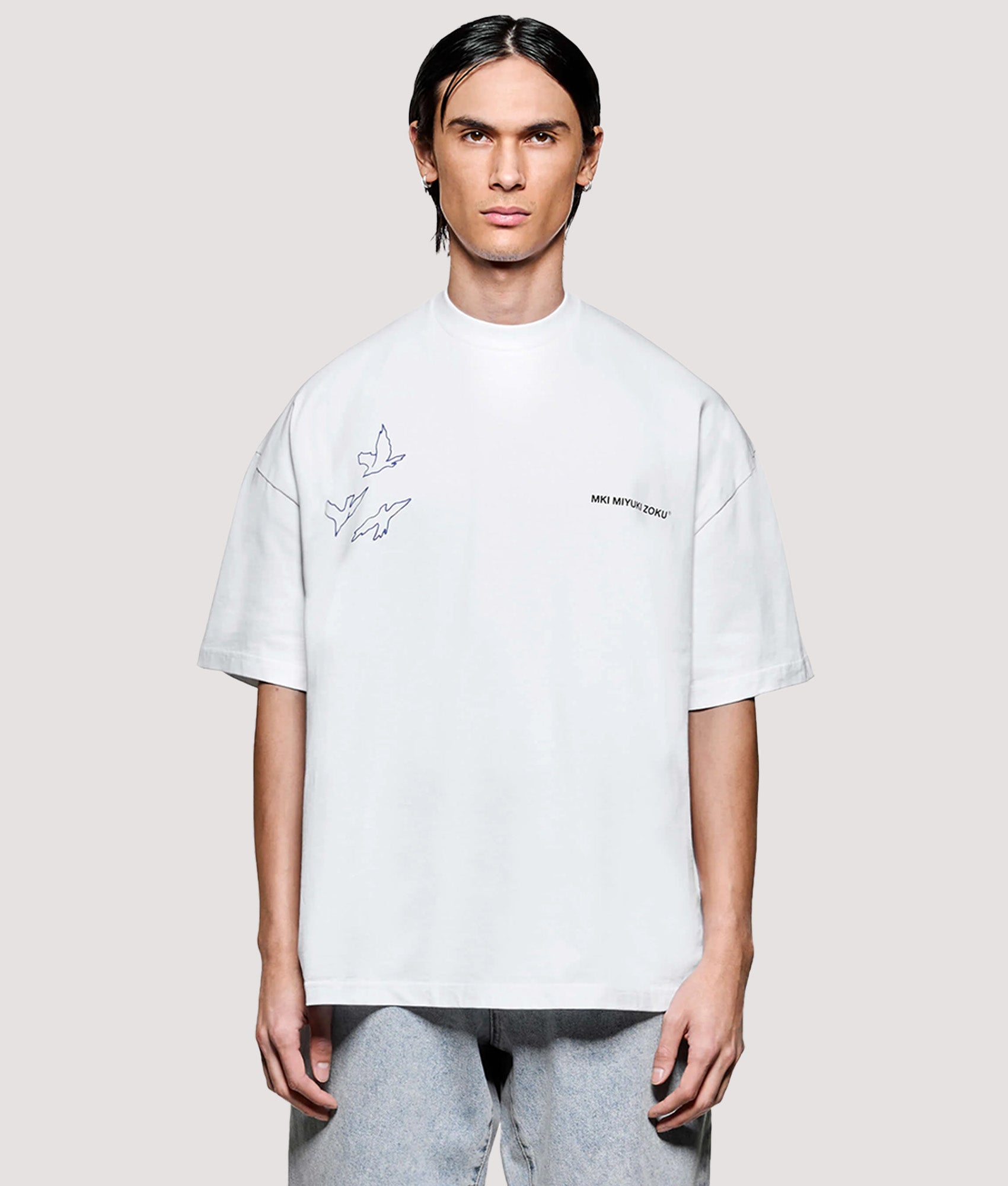 MKI MIYUKI ZOKU Box Fit Flight T-Shirt in White at EQVVS Menswear. Model front shot.