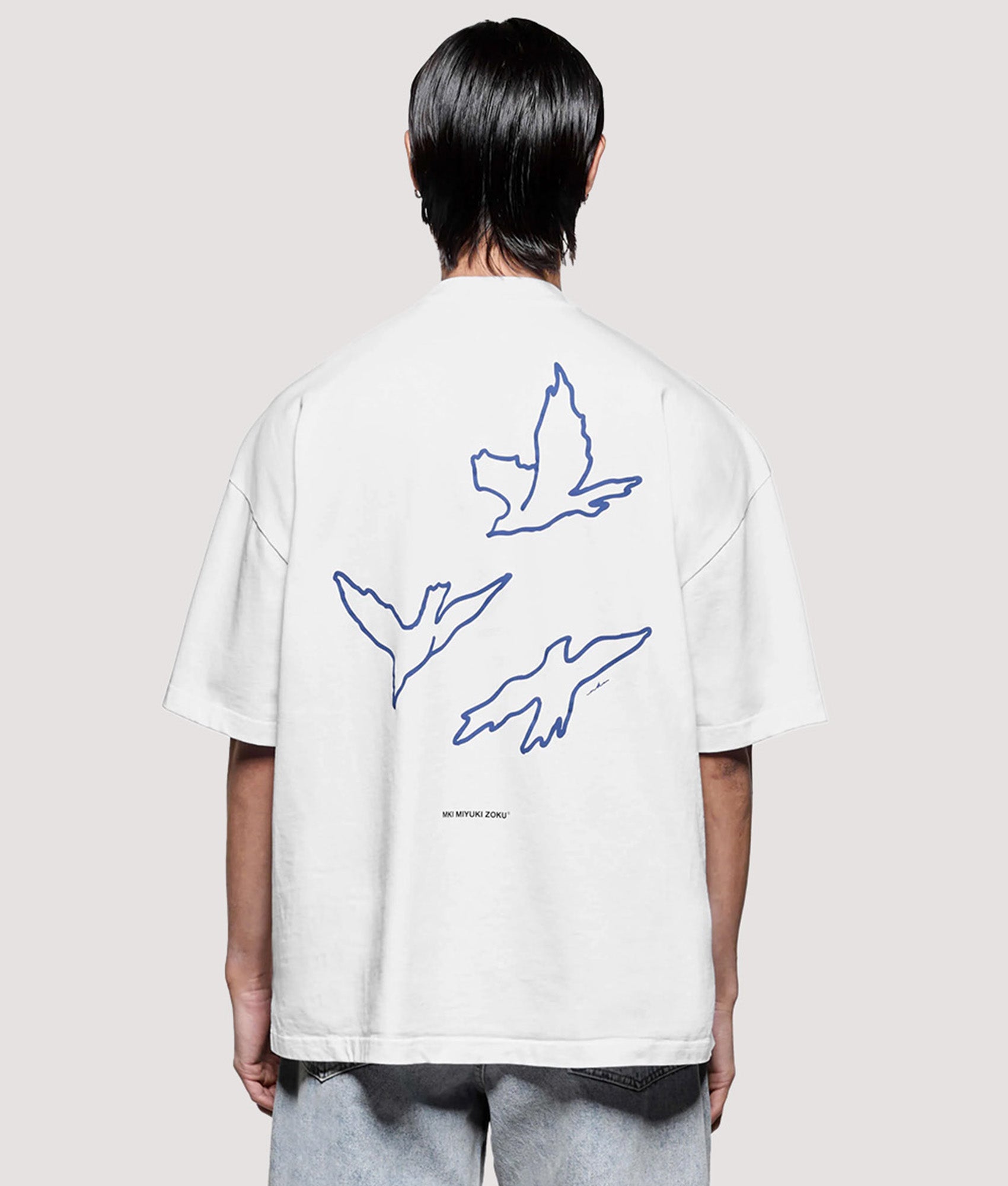 MKI MIYUKI ZOKU Box Fit Flight T-Shirt in White at EQVVS Menswear. Model back shot.