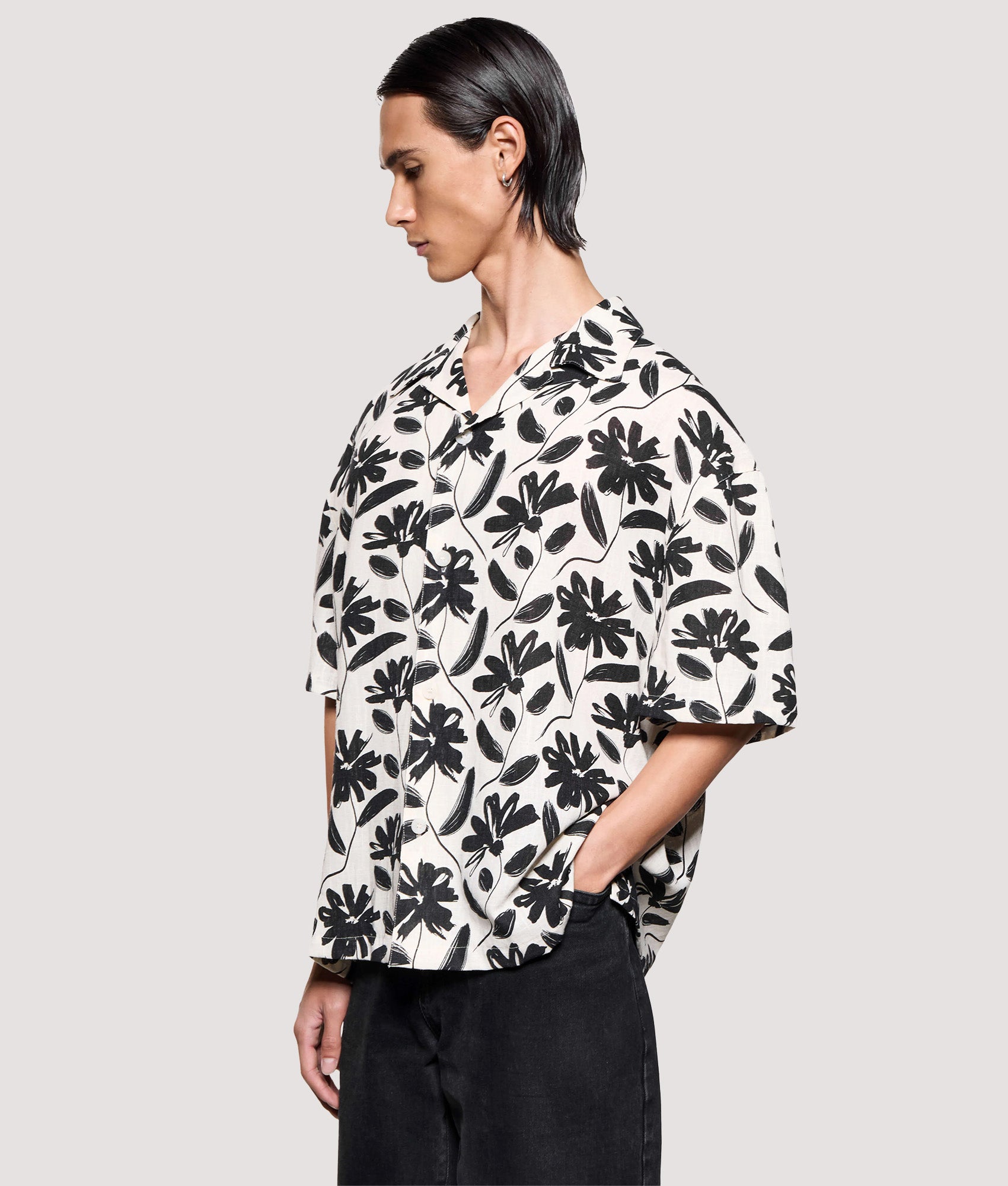 MKI MIYUKI ZOKU Box Fit Floral Linen Short Sleeve Vacation Shirt in Raw at EQVVS Menswear. Angled model front shot.